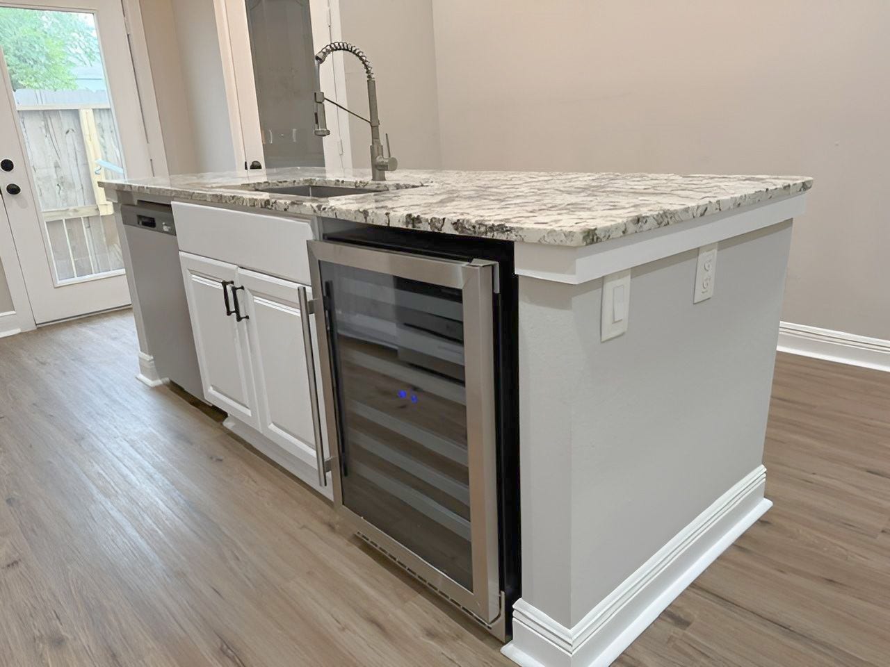 1517 COLORADO Street, Houston, TX 77007 Impressive multifunctional island features a farmhouse-style sink, NEW stainless steel dishwasher, NEW built-in wine refrigerator, and convenient electrical outlets.