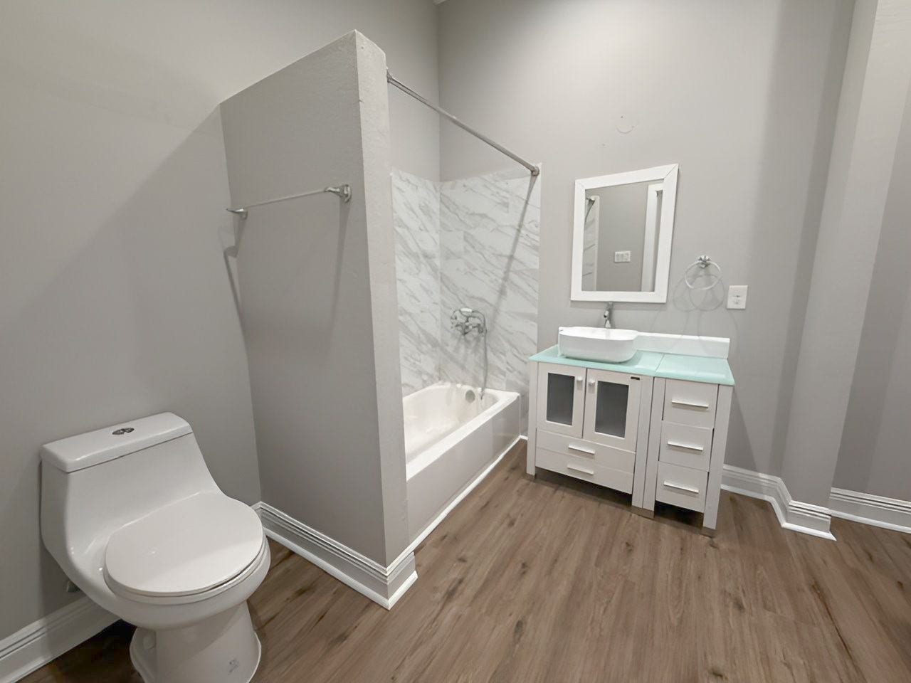 1517 COLORADO Street, Houston, TX 77007 Primary bathroom features a tub/shower combination with marble-look tile surround, contemporary vessel sink vanity, and modern fixtures.