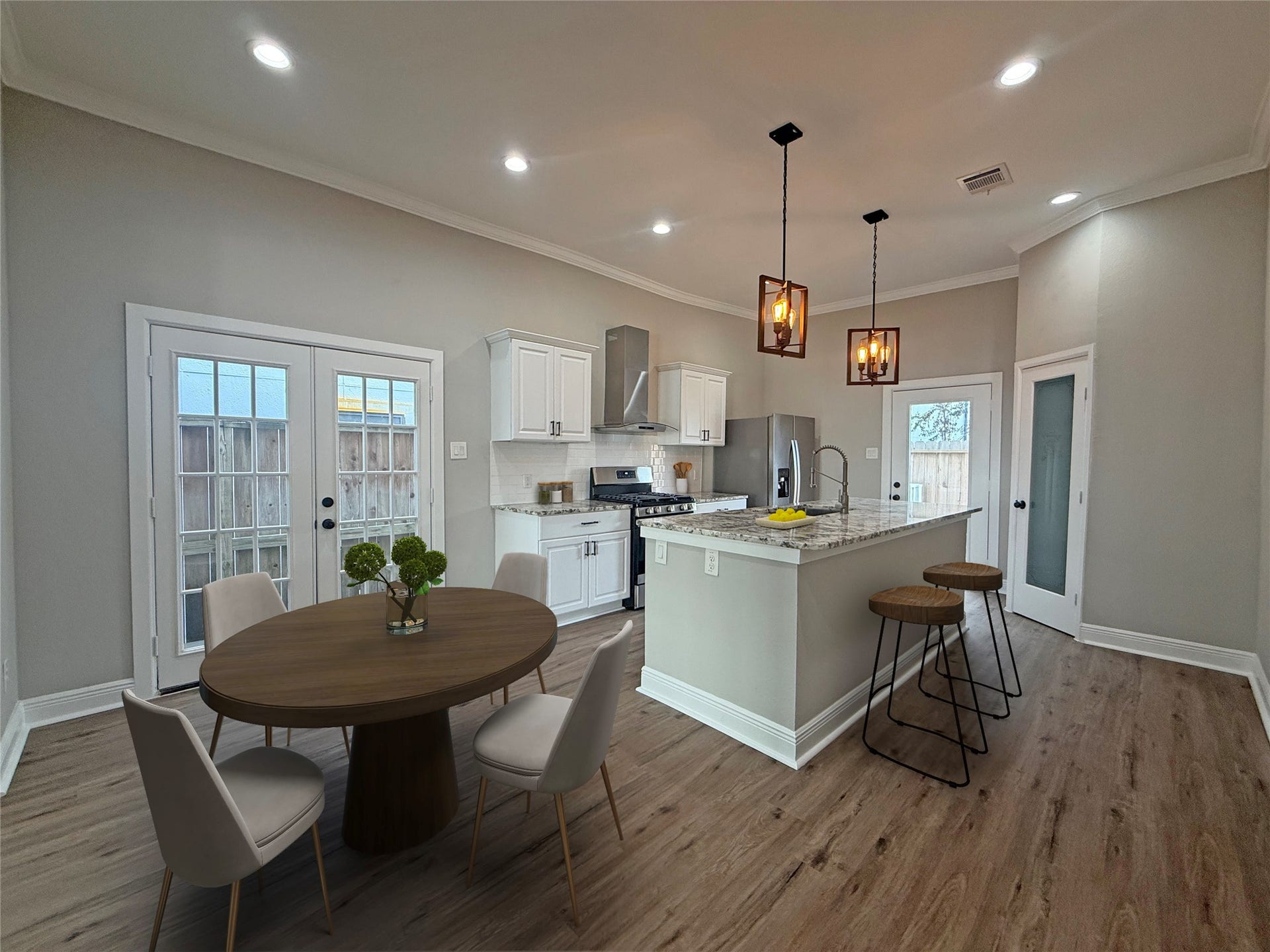 1517 COLORADO Street, Houston, TX 77007 Virtually Staged: Beautifully updated kitchen and dining area, virtually staged to showcase the spacious layout, breakfast bar seating, and dining possibilities. French doors in the dining area open to a small exterior porch, adding natural light and charm.