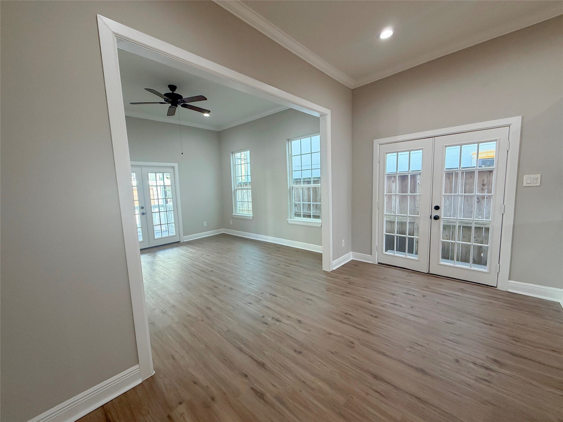1517 COLORADO Street, Houston, TX 77007 Open dining area with French doors providing natural light and access to a small exterior porch, complemented by a wide opening to the adjoining living room.