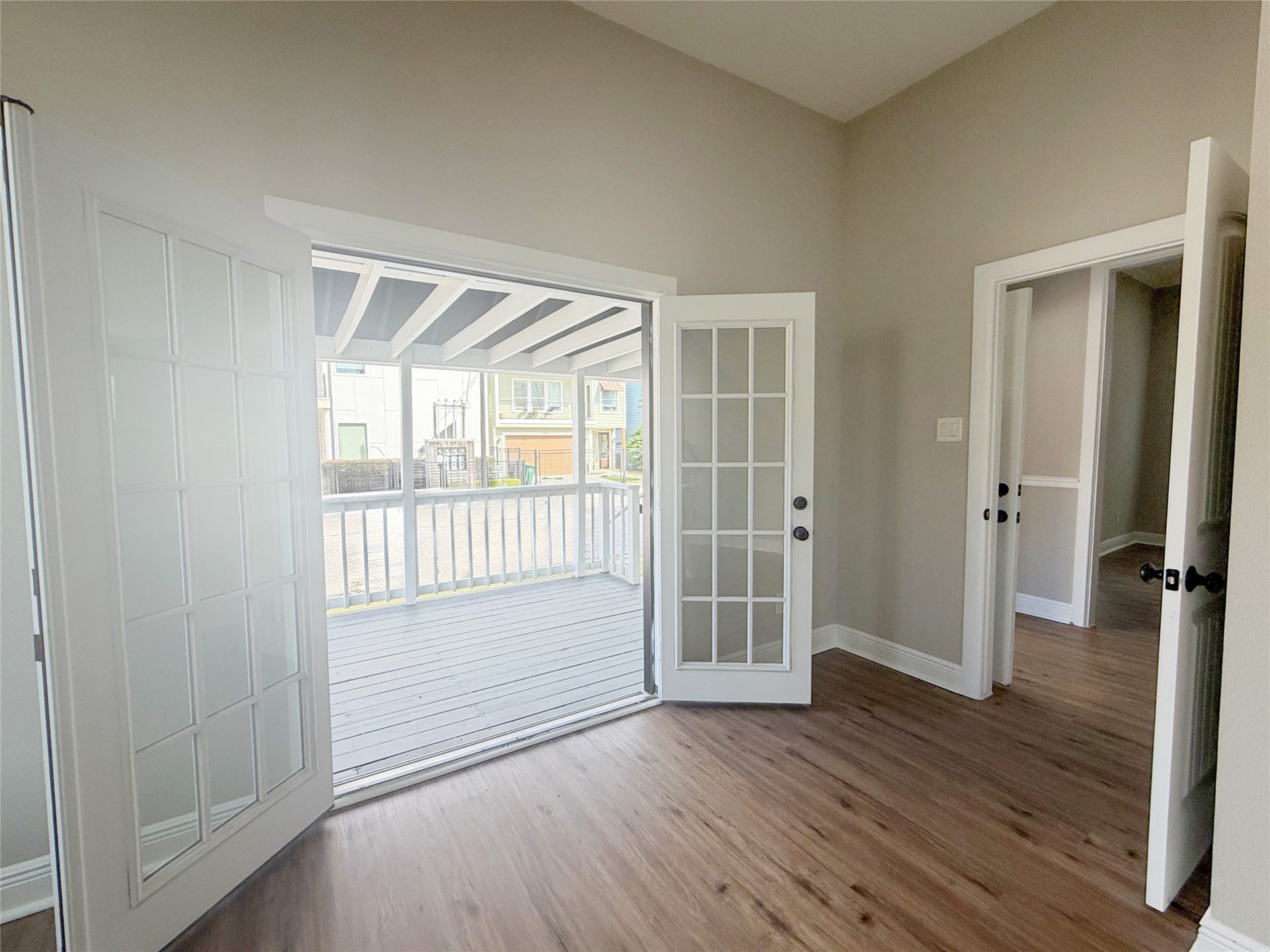 1517 COLORADO Street, Houston, TX 77007 A closer perspective highlights the double French doors and their seamless connection to the covered porch, bringing a wonderful sense of openness to the room.