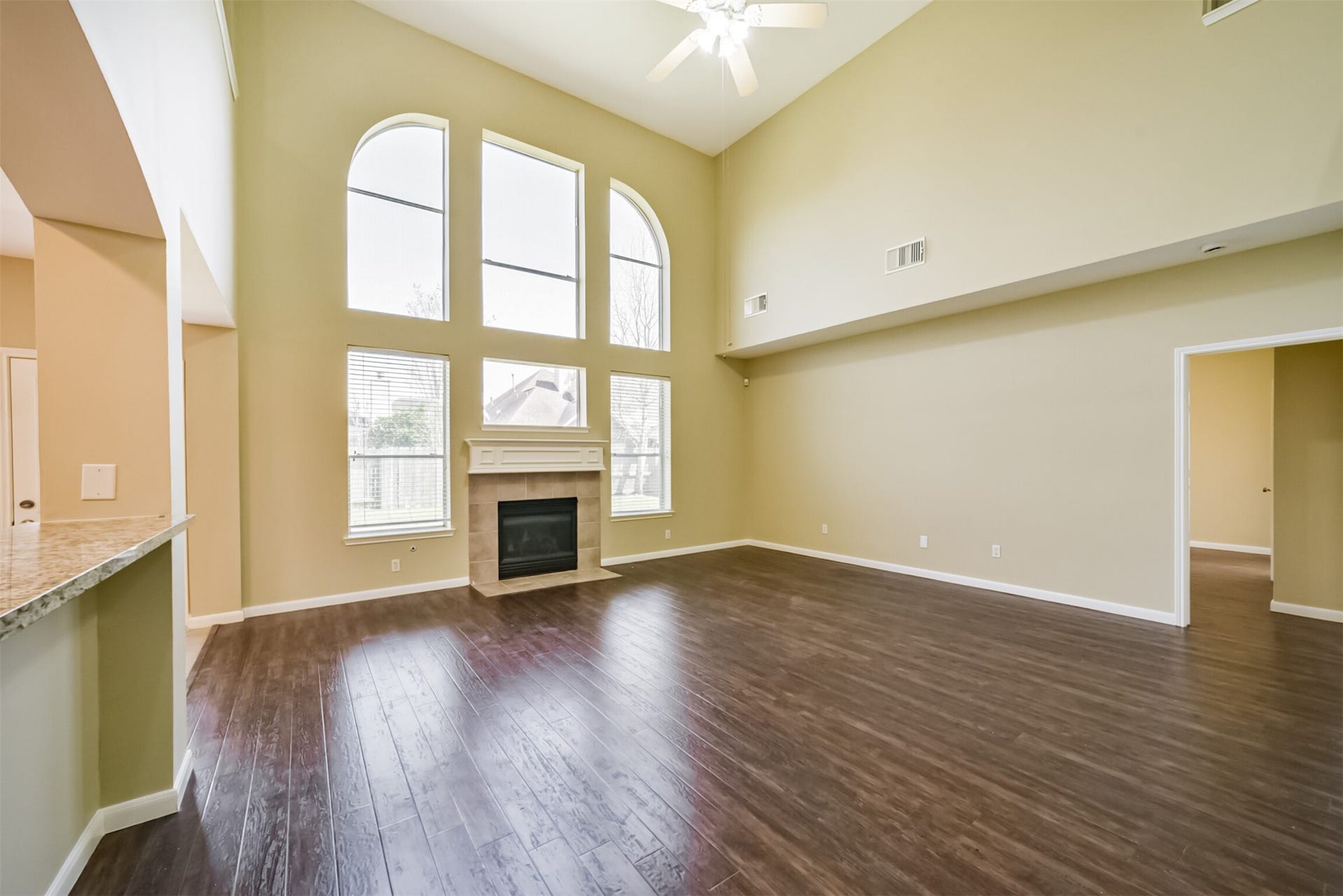 Living room featuring a fireplace and a wall of windows.