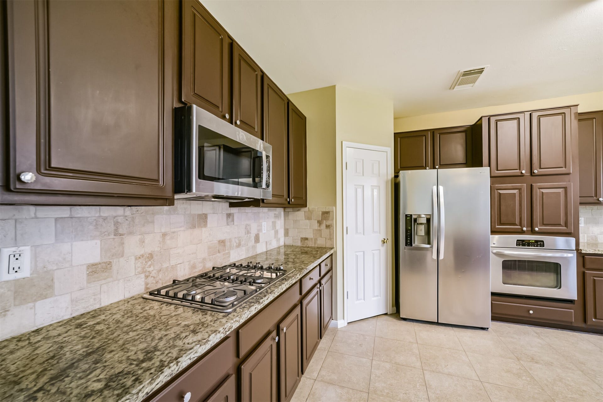 Kitchen featuring a gas cooktop and built-in appliances.