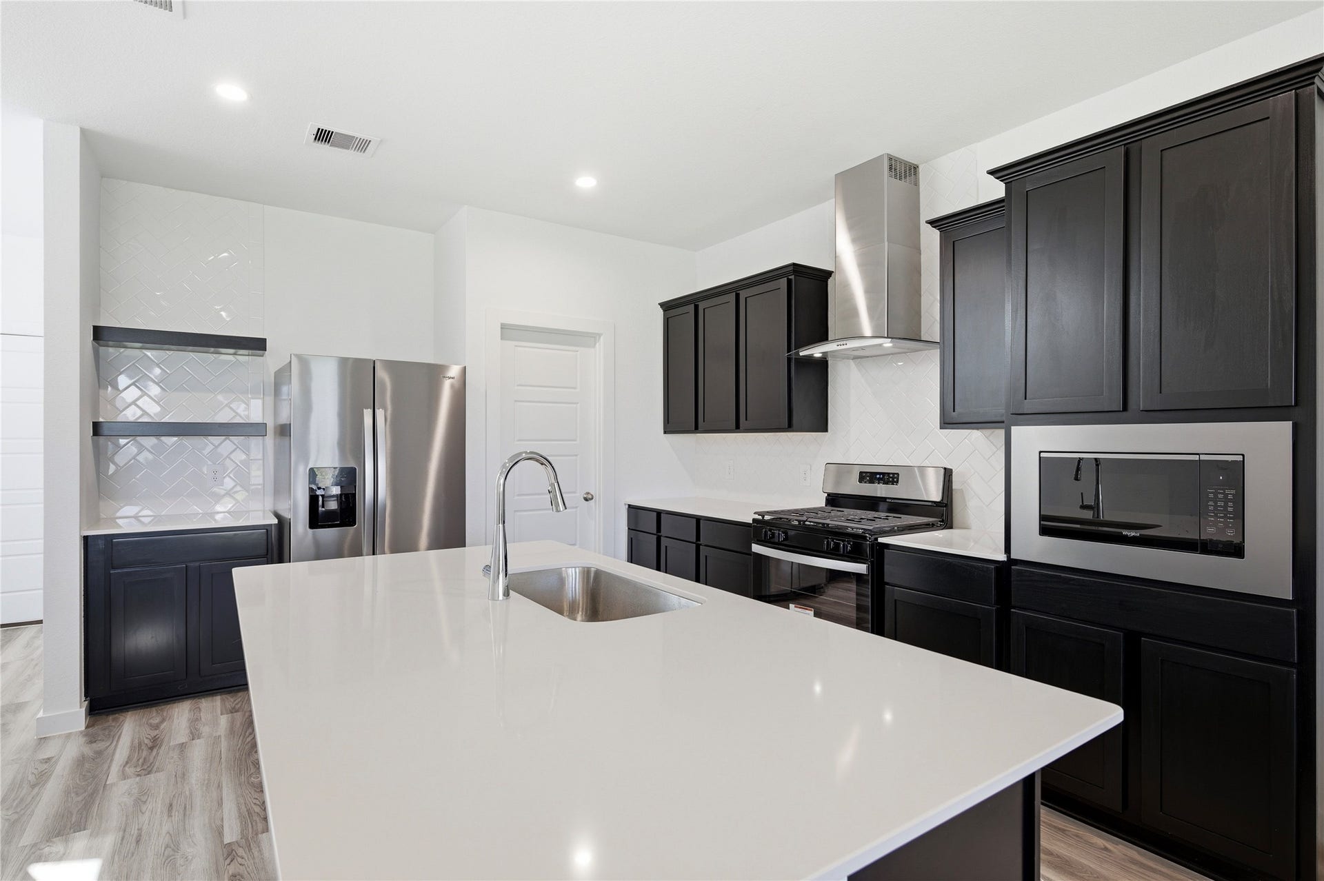 2919 Crown Gate Drive, Houston, TX 77047 Silestone counter tops and dark wood cabinets throughout.