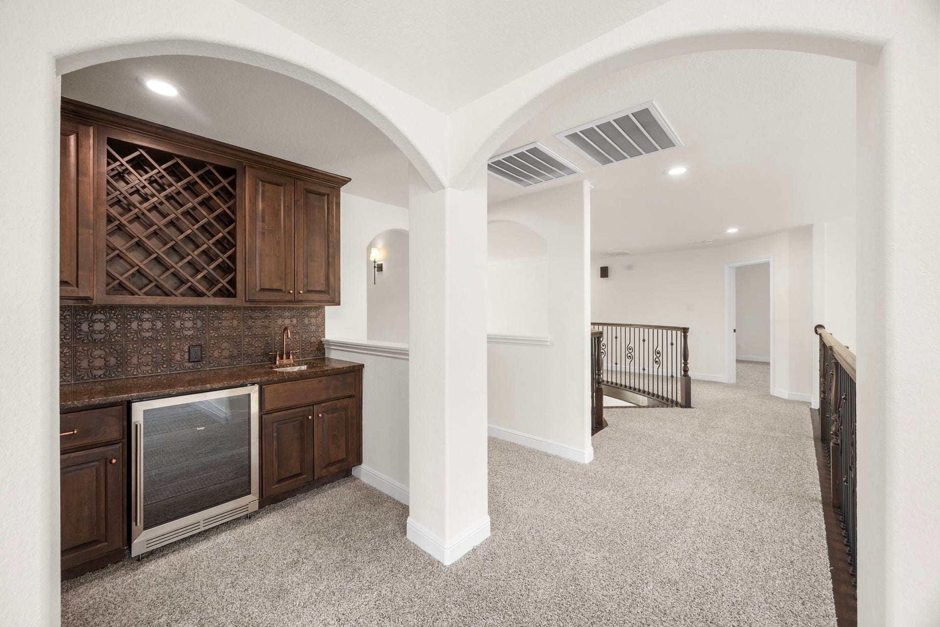 8551 Tombron Grove Road, Magnolia, TX 77354 The stylish wet bar enhances the experience with custom cabinetry, ample counterspace, and convenient beverage service allowing you to host without missing the action.