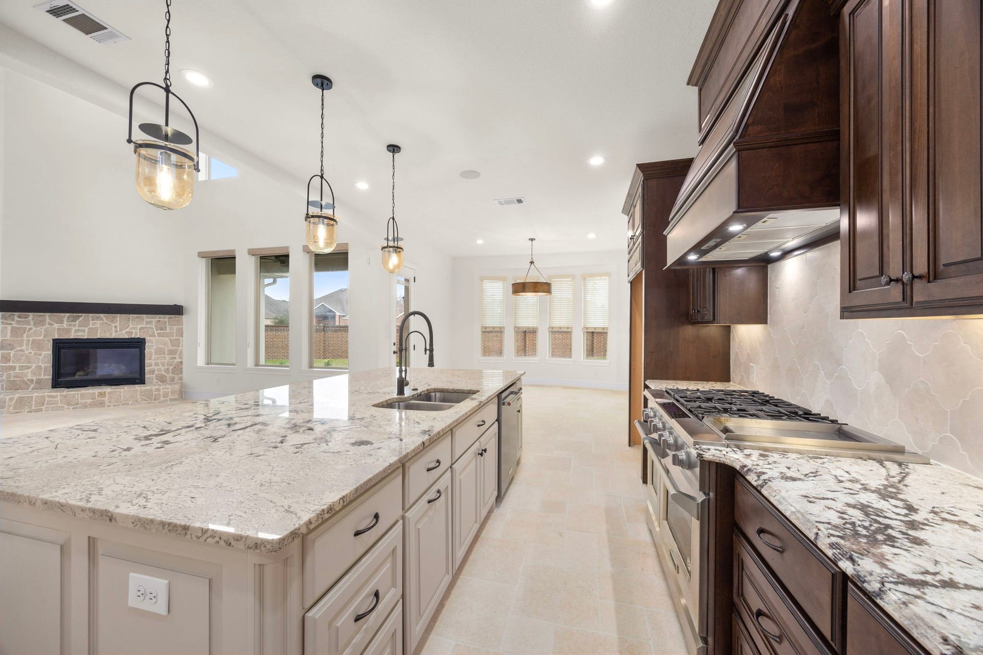 8551 Tombron Grove Road, Magnolia, TX 77354 The large center island anchors ample prep space and additional seating. Designer lighting and high end finishes elevate the space.