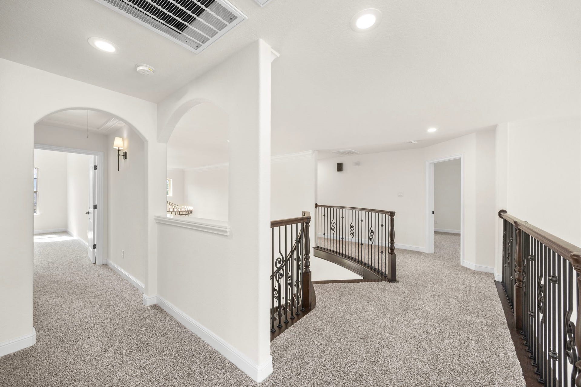 8551 Tombron Grove Road, Magnolia, TX 77354 The upper-level hallway overlooking the staircase offers bright and elegant transition between the home's secondary living spaces.