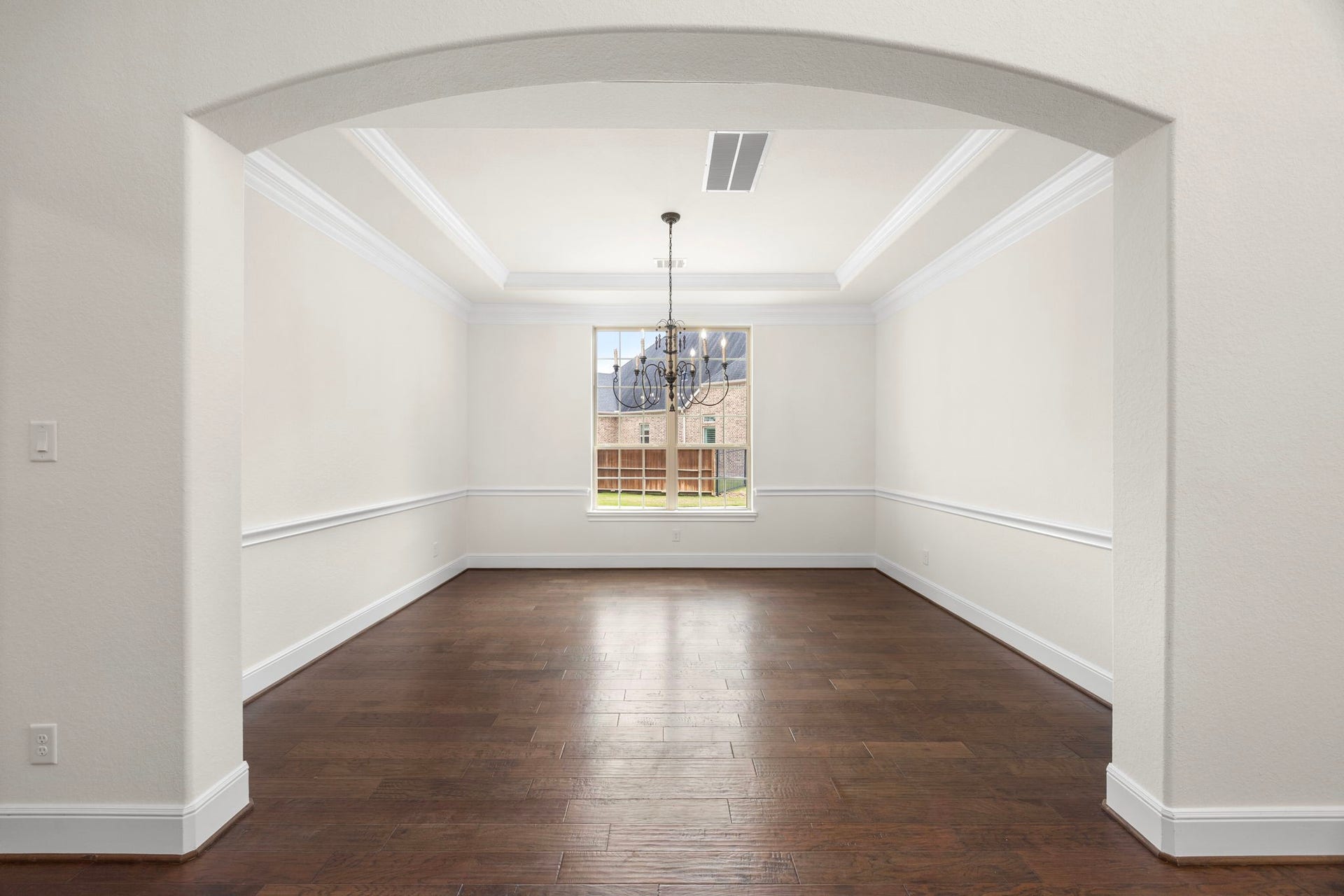 8551 Tombron Grove Road, Magnolia, TX 77354 The elegant formal dining room is designed to make every gathering feel special. Framed by architectural details, the space features rich hardwood flooring, sophisticated crown molding, and custom lighting that creates a warm inviting ambiance.