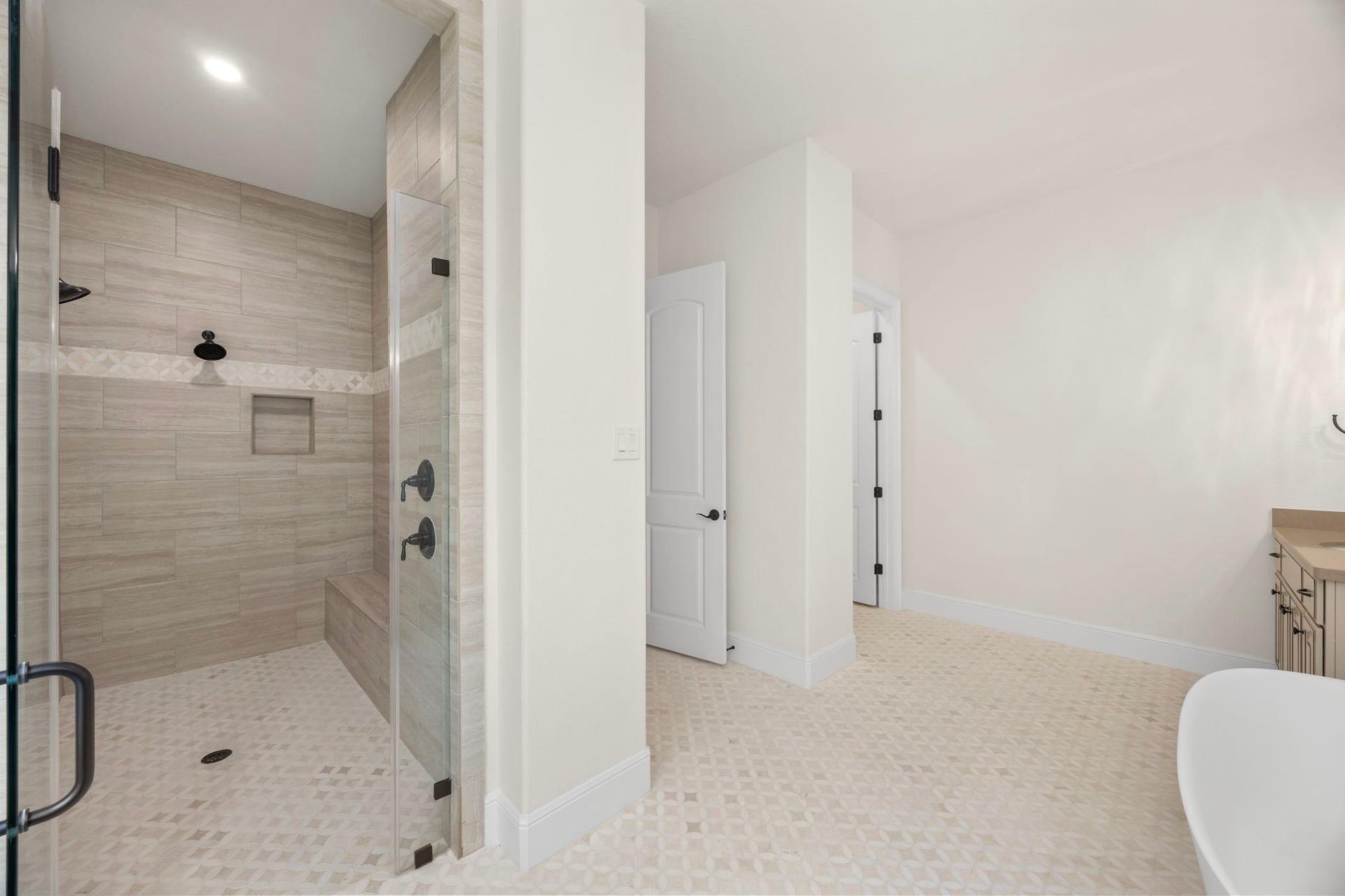 8551 Tombron Grove Road, Magnolia, TX 77354 This luxurious primary bathroom is a true spa retreat, designed with elegance and comfort in mind.