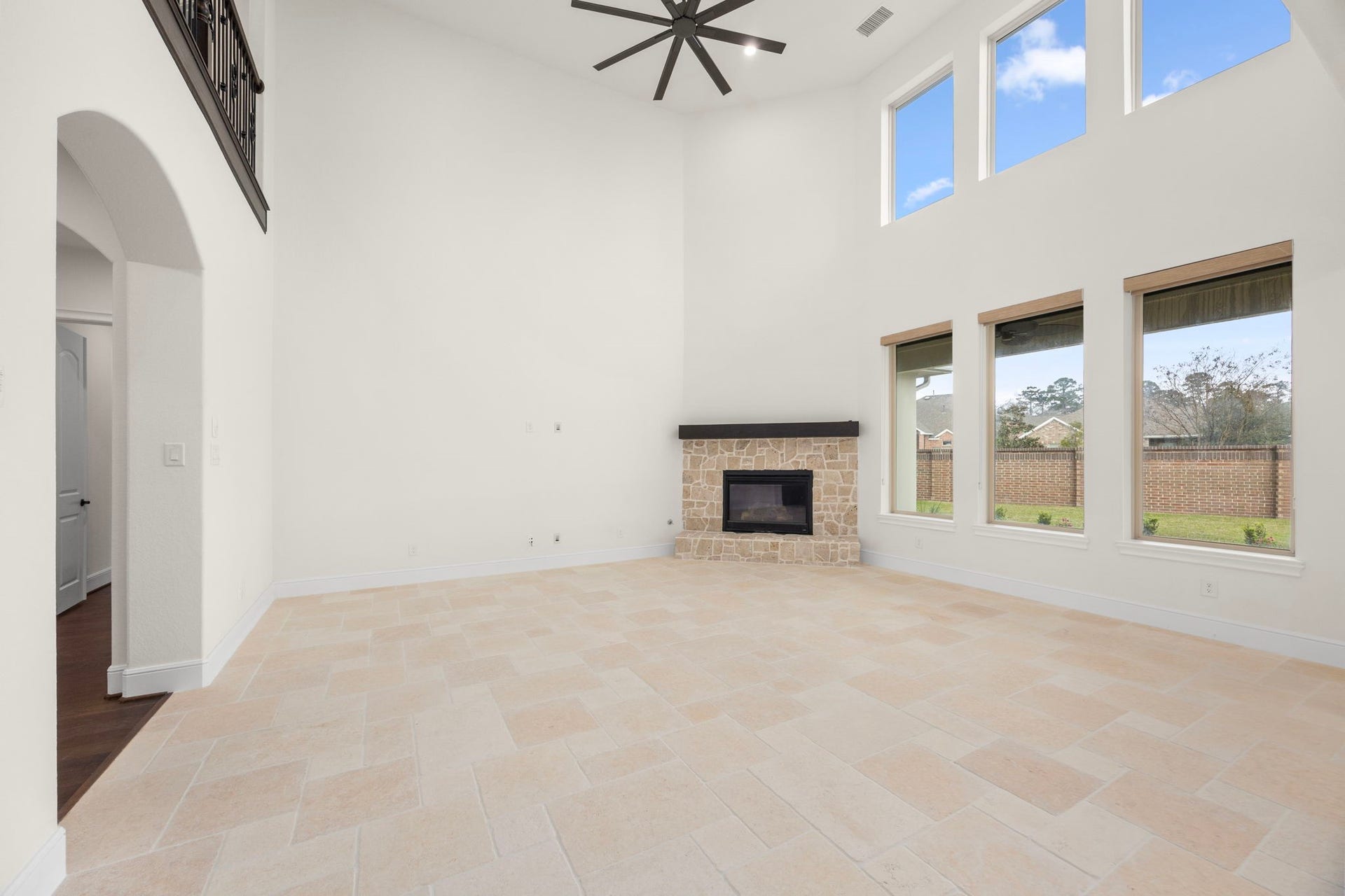 8551 Tombron Grove Road, Magnolia, TX 77354 The family room features rustic limestone flooring with an impressive stone fireplace that serves as a focal point. This room blends rustic charm with refined elegance creating an inviting environment for relaxing evenings.