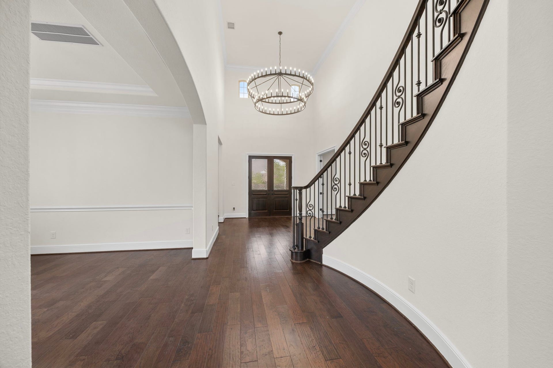 8551 Tombron Grove Road, Magnolia, TX 77354 Bright and welcoming entryway featuring a stunning statement light fixture, soaring ceilings, and beautiful architectural details that create an elegant first impression.