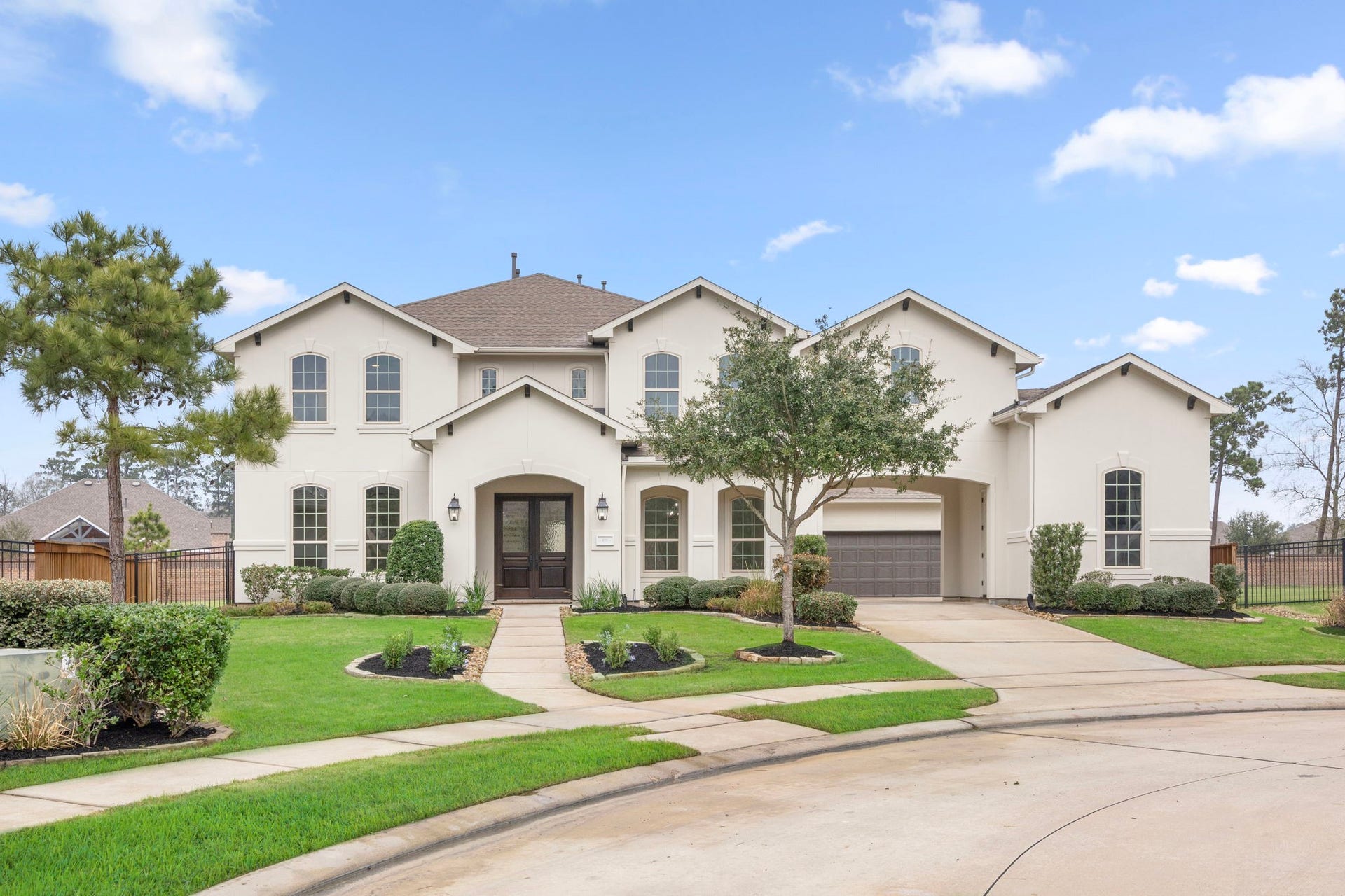 8551 Tombron Grove Road, Magnolia, TX 77354 The front of this magnificent estate home makes a powerful first impression with its stately architecture and commanding presence.