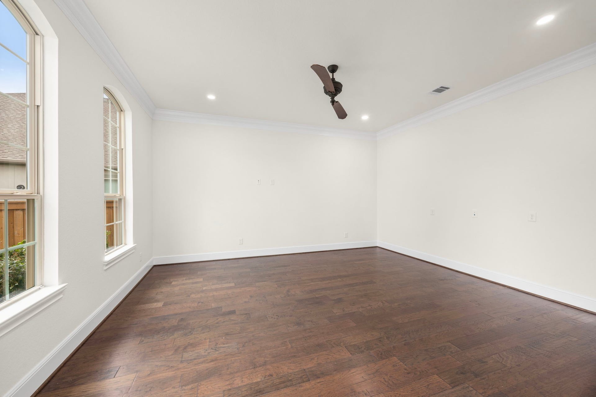 8551 Tombron Grove Road, Magnolia, TX 77354 Private executive home office study offers a spacious workspace. Featuring hardwood flooring and elegant crown molding that create an inspiring work environment.