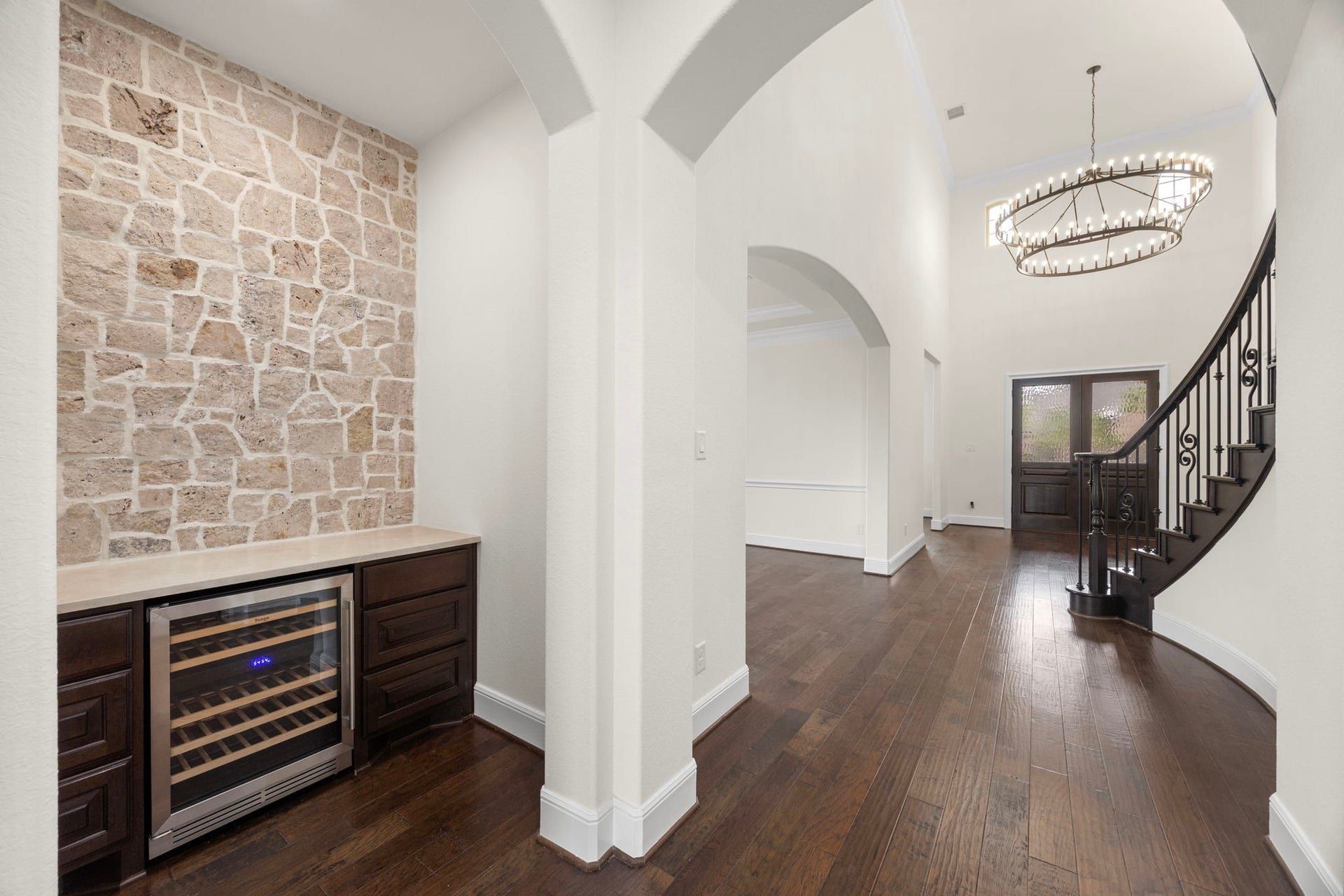 8551 Tombron Grove Road, Magnolia, TX 77354 The wine grotto offers a sophisticated space designed for both storage and stylish entertaining. Thoughtfully appointed, this inviting area features custom cabinetry, striking stone accent wall, and ample counterspace for serving and display.