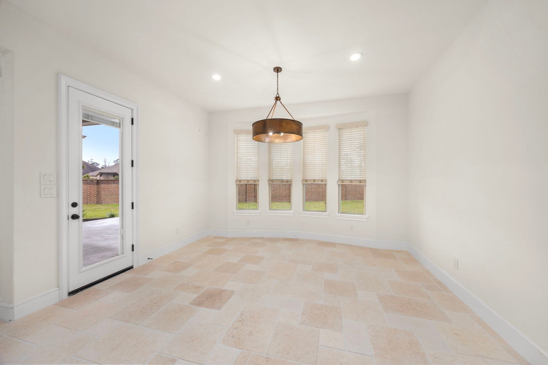 8551 Tombron Grove Road, Magnolia, TX 77354 The charming breakfast nook offers a bright and inviting space, perfect for casual dining or morning gatherings. Surrounded by generous windows, the area is filled with natural light creating a warm cheerful atmosphere to start the day.