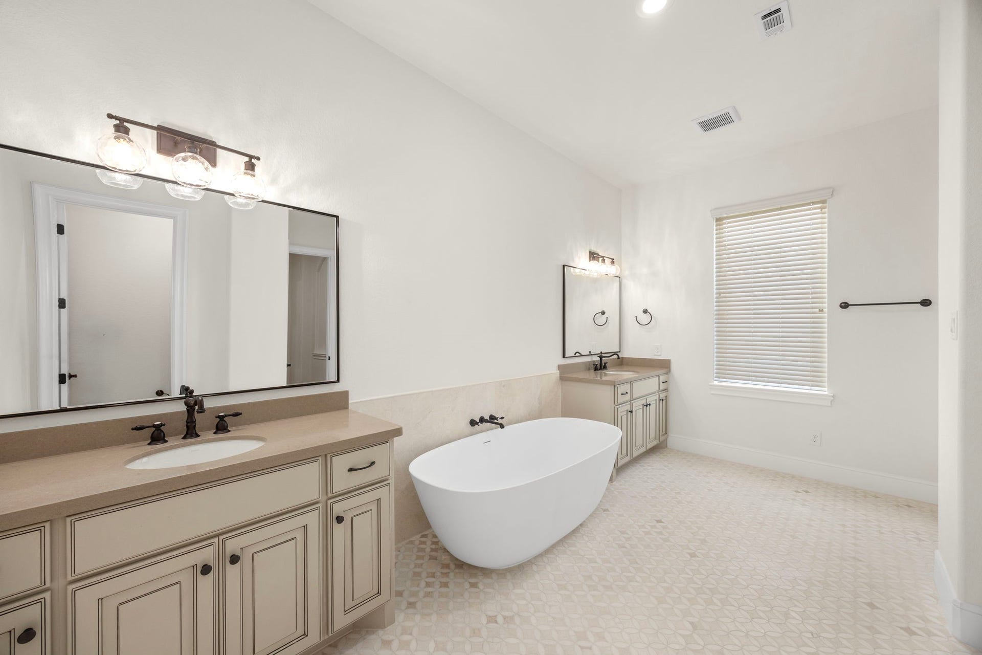 8551 Tombron Grove Road, Magnolia, TX 77354 Beautifully appointed and impeccably designed, this primary bath delivers the ultimate in comfort and sophistication. Showcasing custom marble flooring, upscale finishes, designer lighting, and refined fixtures.