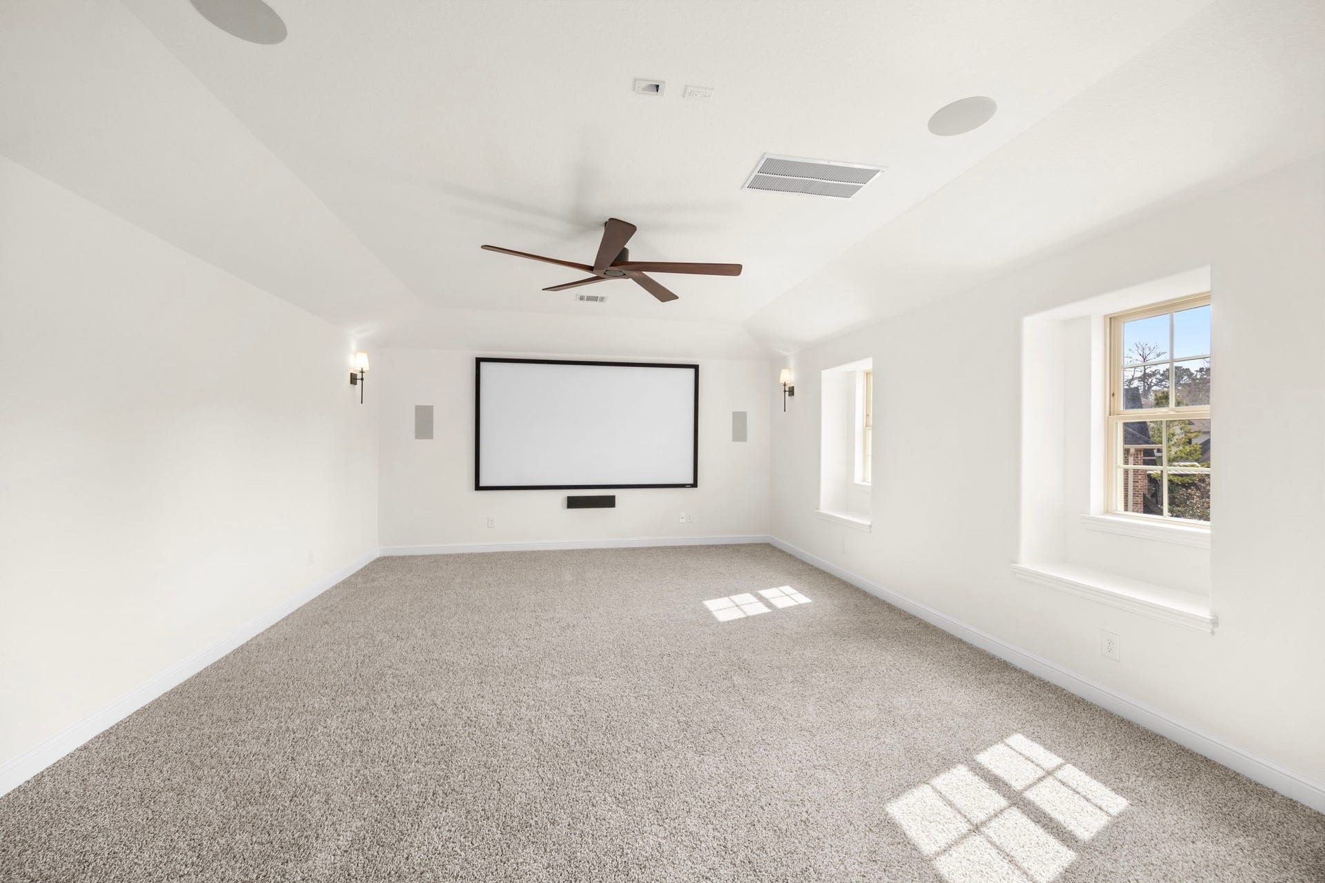 8551 Tombron Grove Road, Magnolia, TX 77354 The dedicated media room is a true in-home theater experience, thoughtfully designed for immersive entertainment. Spacious and inviting, this room easily accommodates tiered seating or oversized loungers, making it perfect for movie nights or watching the big game.