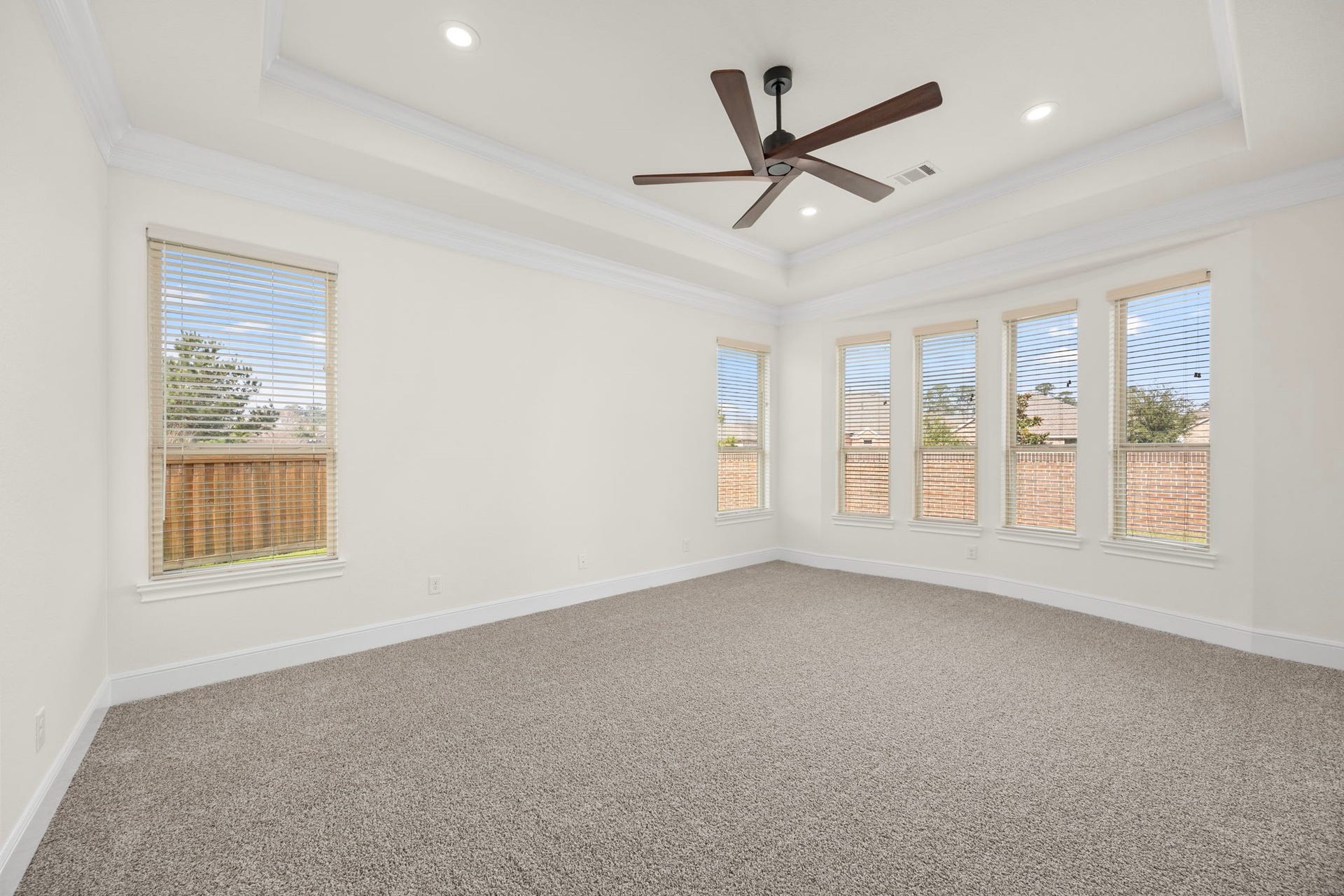 8551 Tombron Grove Road, Magnolia, TX 77354 Large windows fill the room with soft natural light. Designed with both comfort and sophistication in mind, the primary suite offers a peaceful escape.