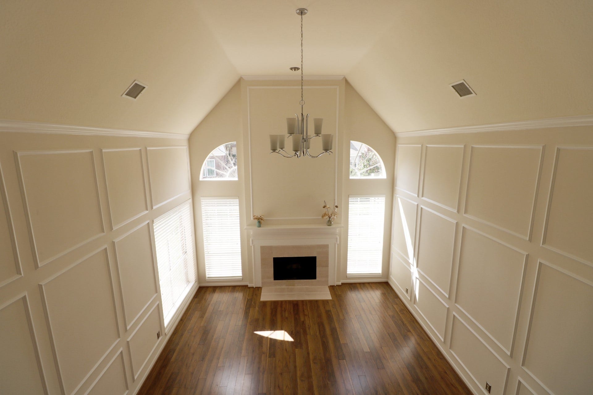 Overlook of family room with souring ceiling