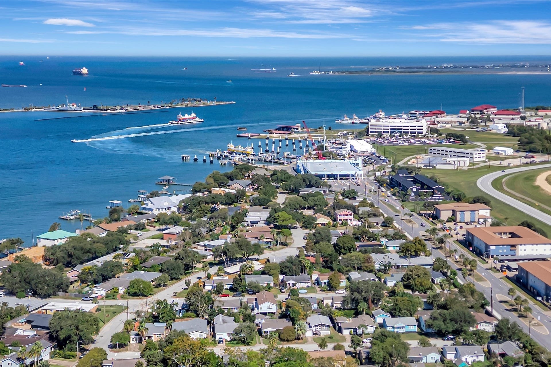 7071 N Holiday Drive, Galveston, TX 77550 Aerial perspective of the surrounding neighborhood and Galveston waterways.