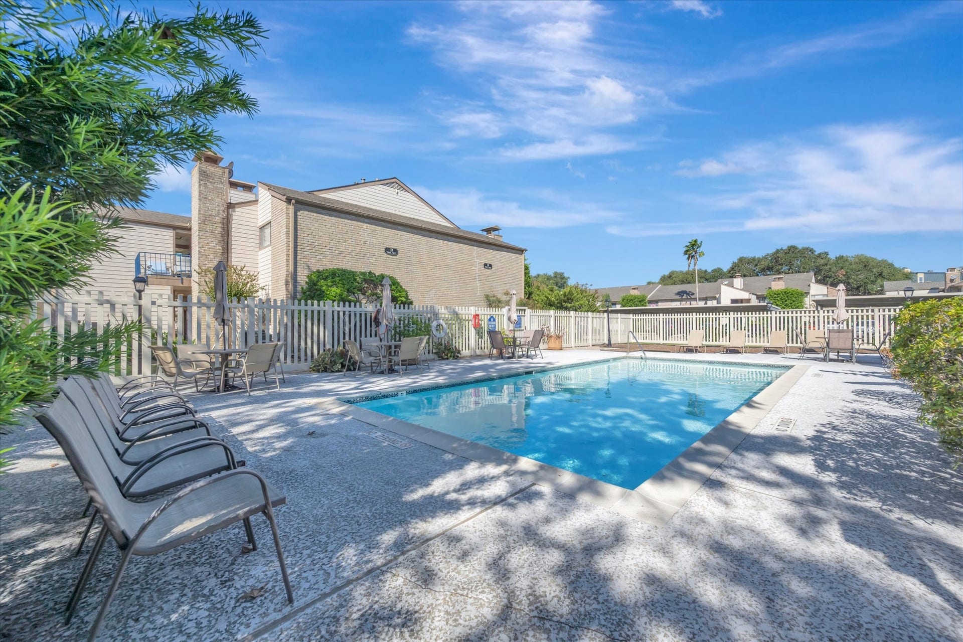 7071 N Holiday Drive, Galveston, TX 77550 Another view of the community pool and surrounding outdoor seating area.