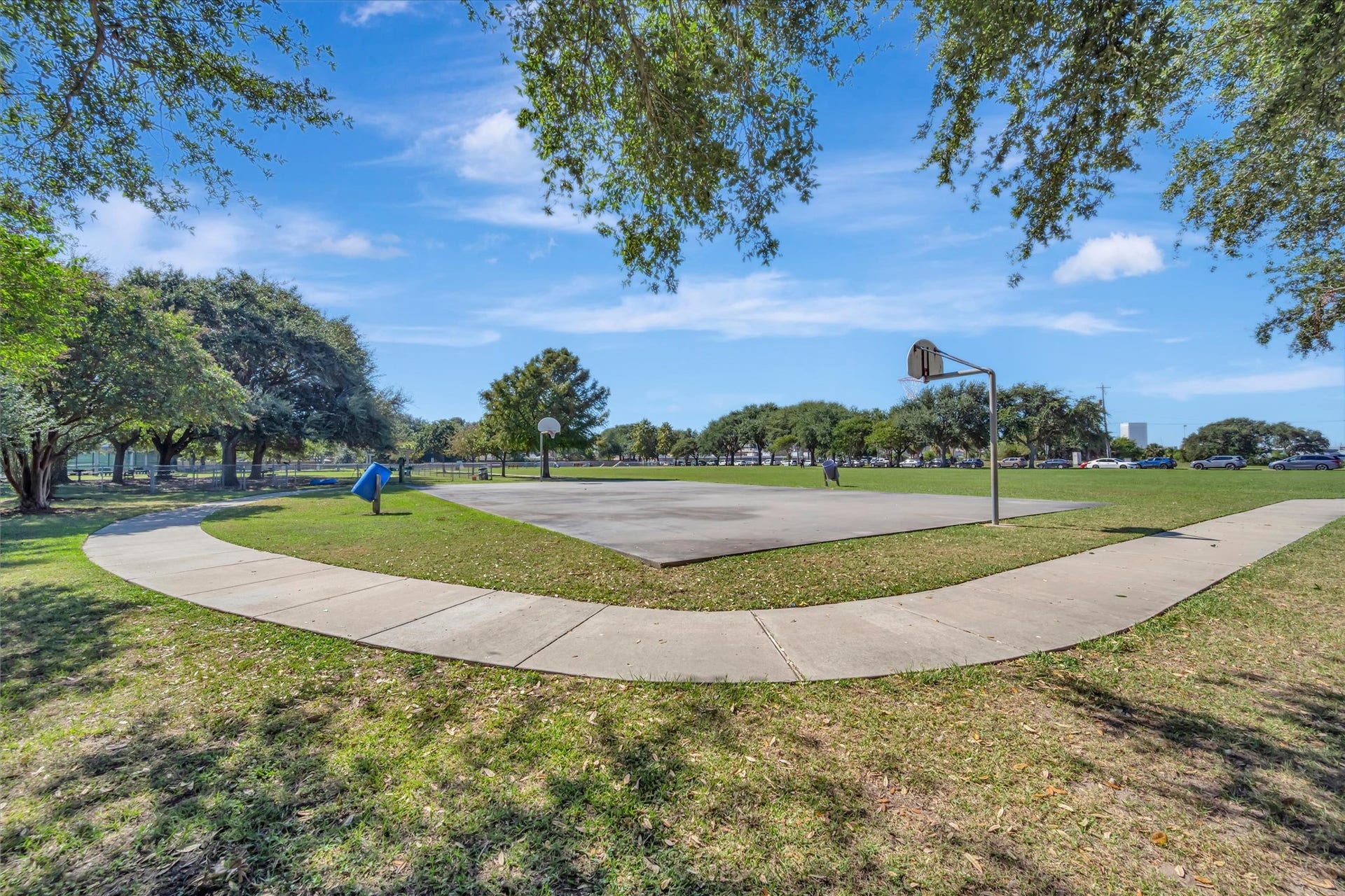 7071 N Holiday Drive, Galveston, TX 77550 Open green space and established trees within the community grounds.