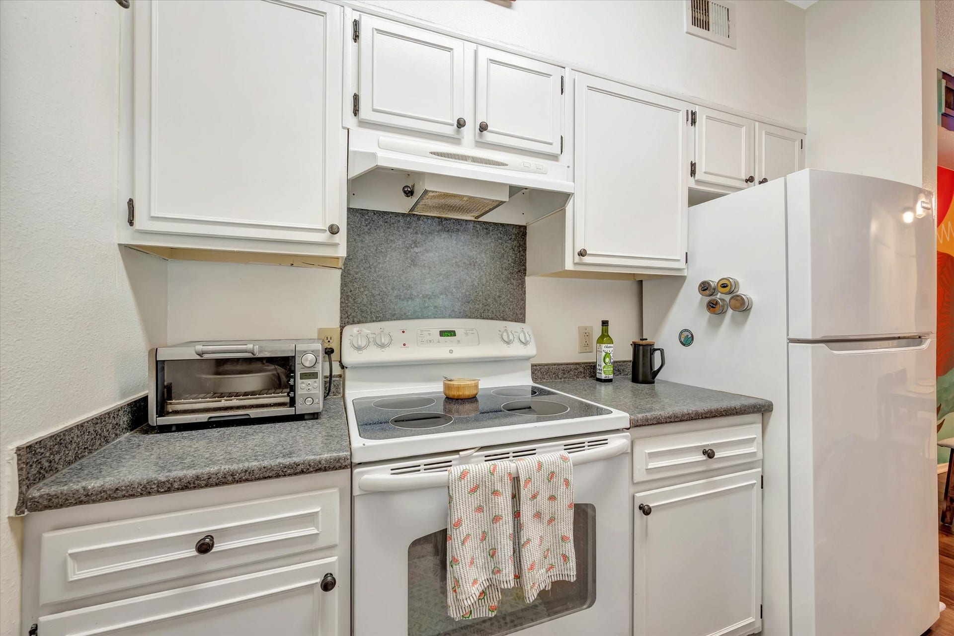 7071 N Holiday Drive, Galveston, TX 77550 Additional kitchen view showing the refrigerator, range and upper and lower cabinetry.