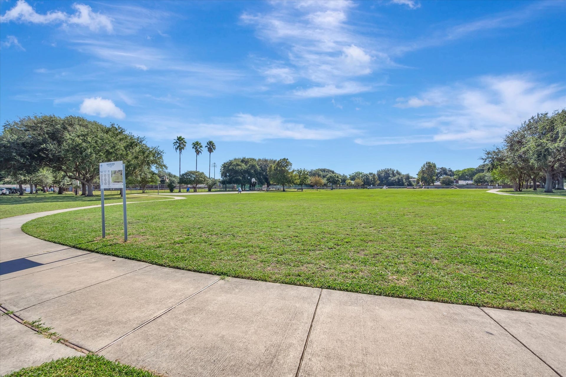7071 N Holiday Drive, Galveston, TX 77550 Additional view of the communitys open lawn and paved walkways.