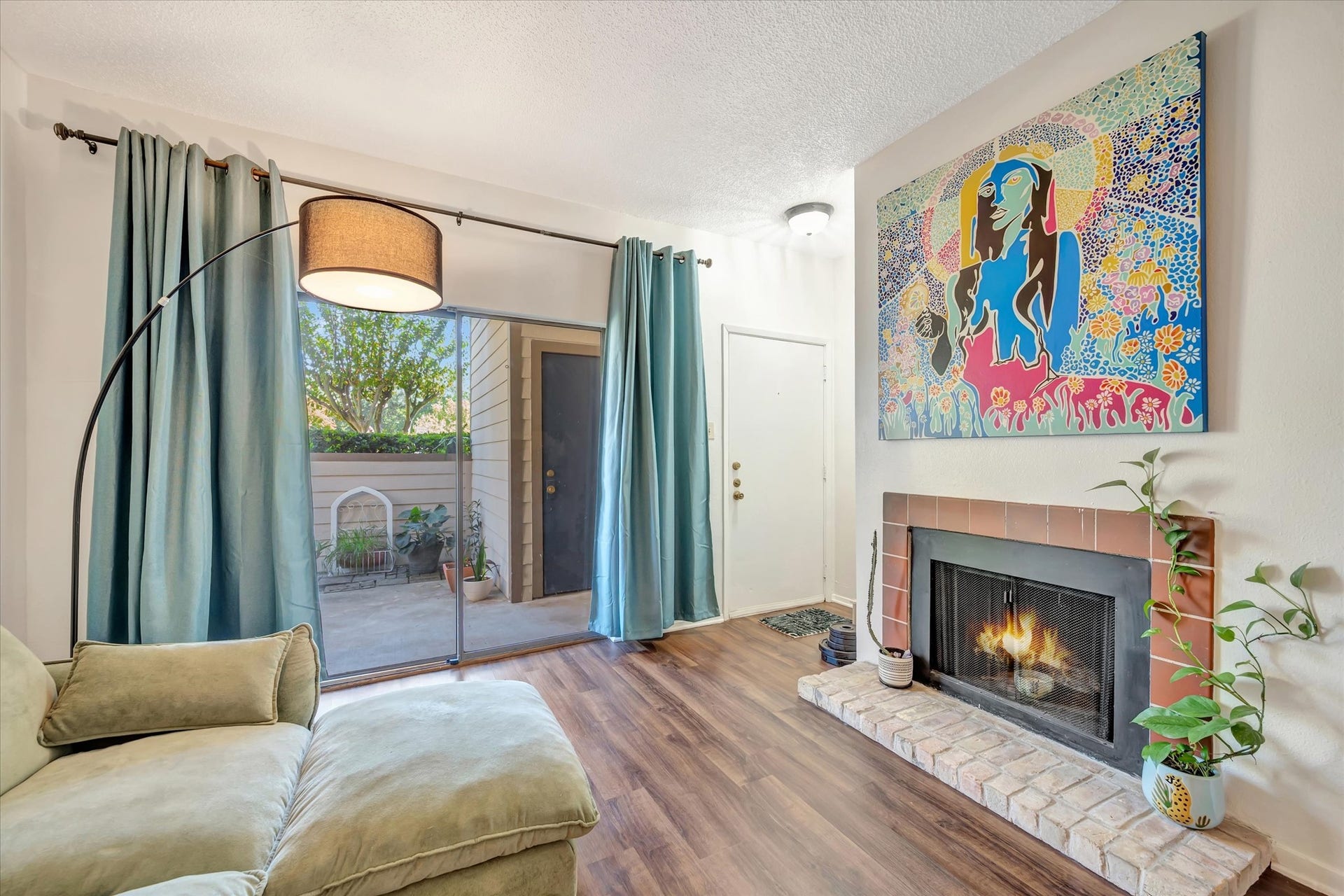 7071 N Holiday Drive, Galveston, TX 77550 Fireplace adds a cozy focal point to the living area, with patio access nearby.
