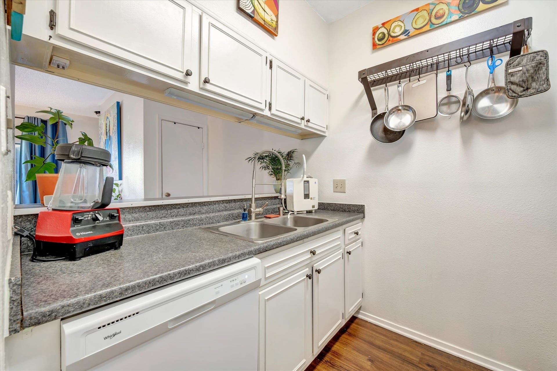 7071 N Holiday Drive, Galveston, TX 77550 Kitchen with white cabinetry, countertop workspace and a window above the sink.