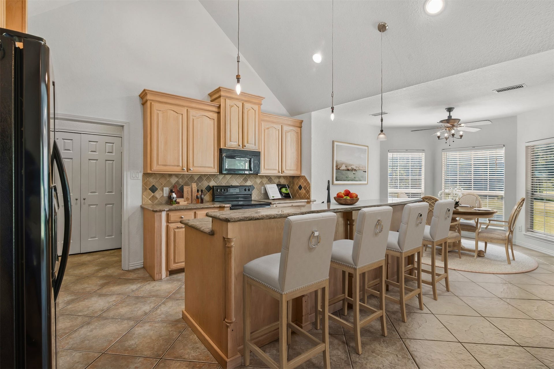 Another view of the kitchen with large breakfast bar enhanced by decorative columns across the back. Kitchen was recently painted. **Virtually Staged**