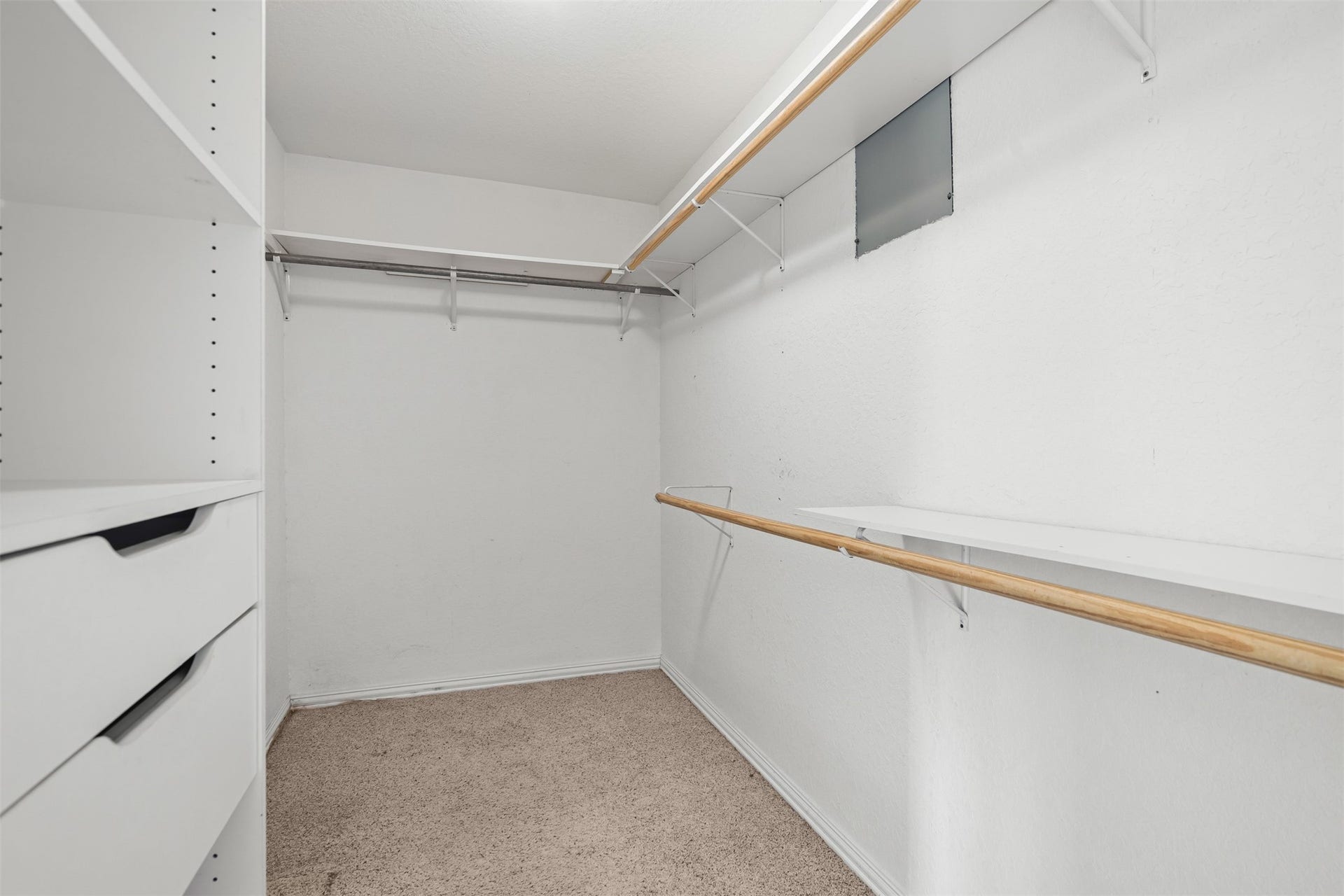 Spacious walk-in closet in the primary bedroom with built in storage.