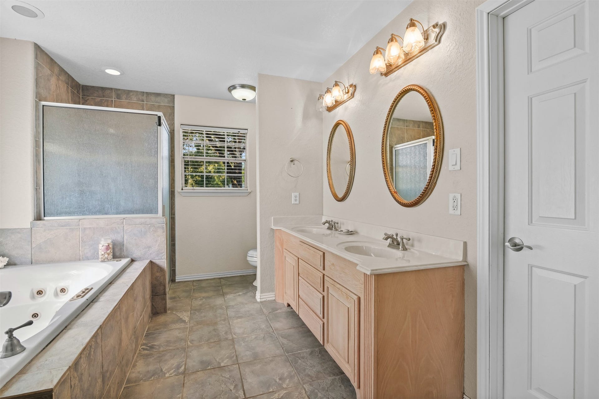 The primary bathroom also features double sinks and ample under counter storage space.