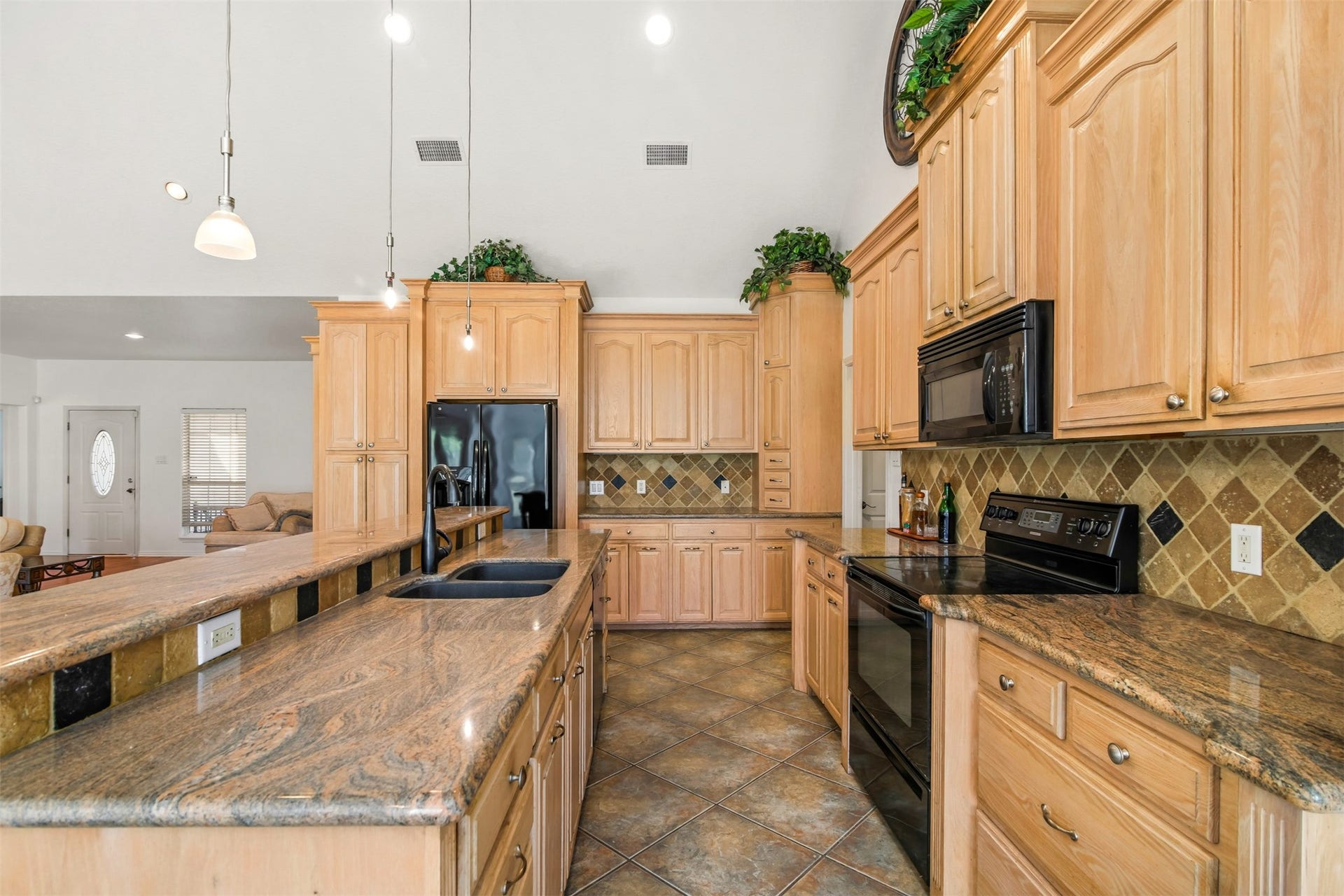 The kitchen has ample storage for all your needs and plenty of counter space for the chef to prep. The kitchen also features matching black appliances and large double door pantry.