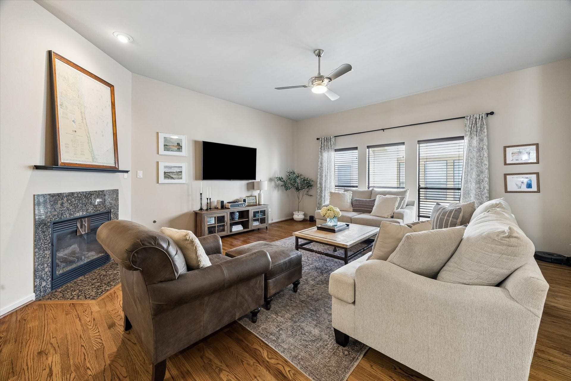 Large living area on second floor with large, picturesque windows, gas log fireplace and half bath