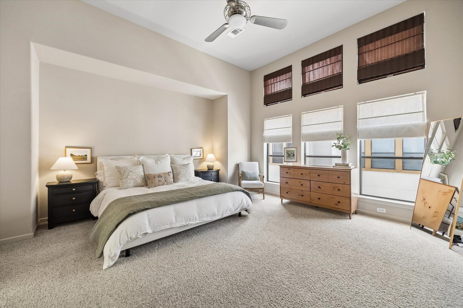 Large primary suite on third floor with high ceilings, natural light and his and hers closets