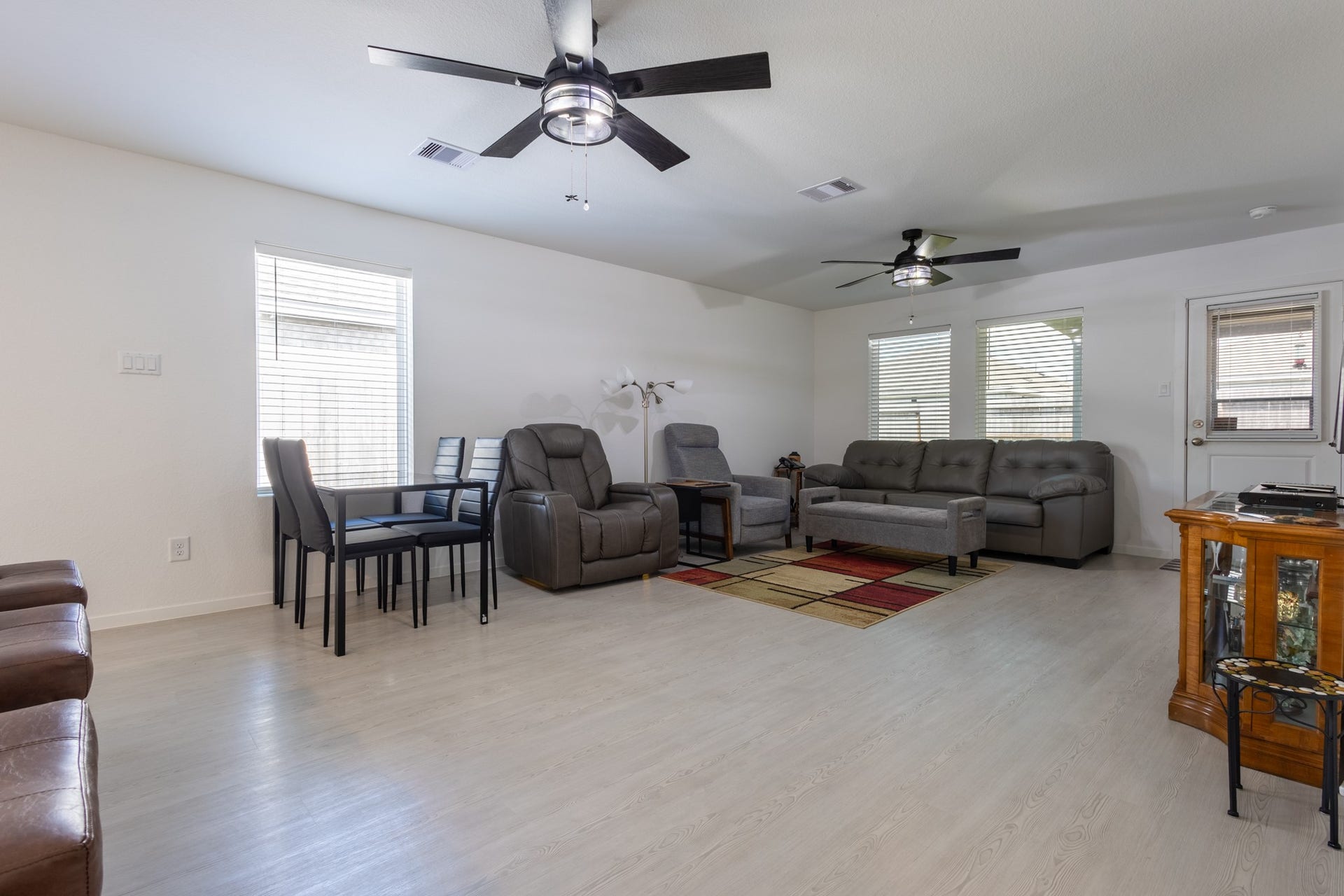 5806 Standpiper Loop, Baytown, TX 77521 A cozy, relaxed family room view highlighting the large windows that frame the backyard oasis while providing effortless indoor-outdoor flow.