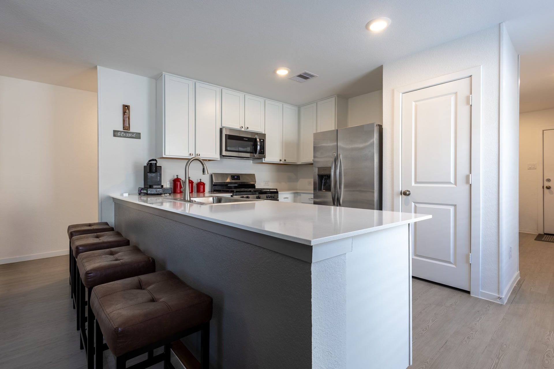 5806 Standpiper Loop, Baytown, TX 77521 The central kitchen island highlights a fabulous custom foot bar upgrade along the base, making it the perfect spot for casual counter-height dining.