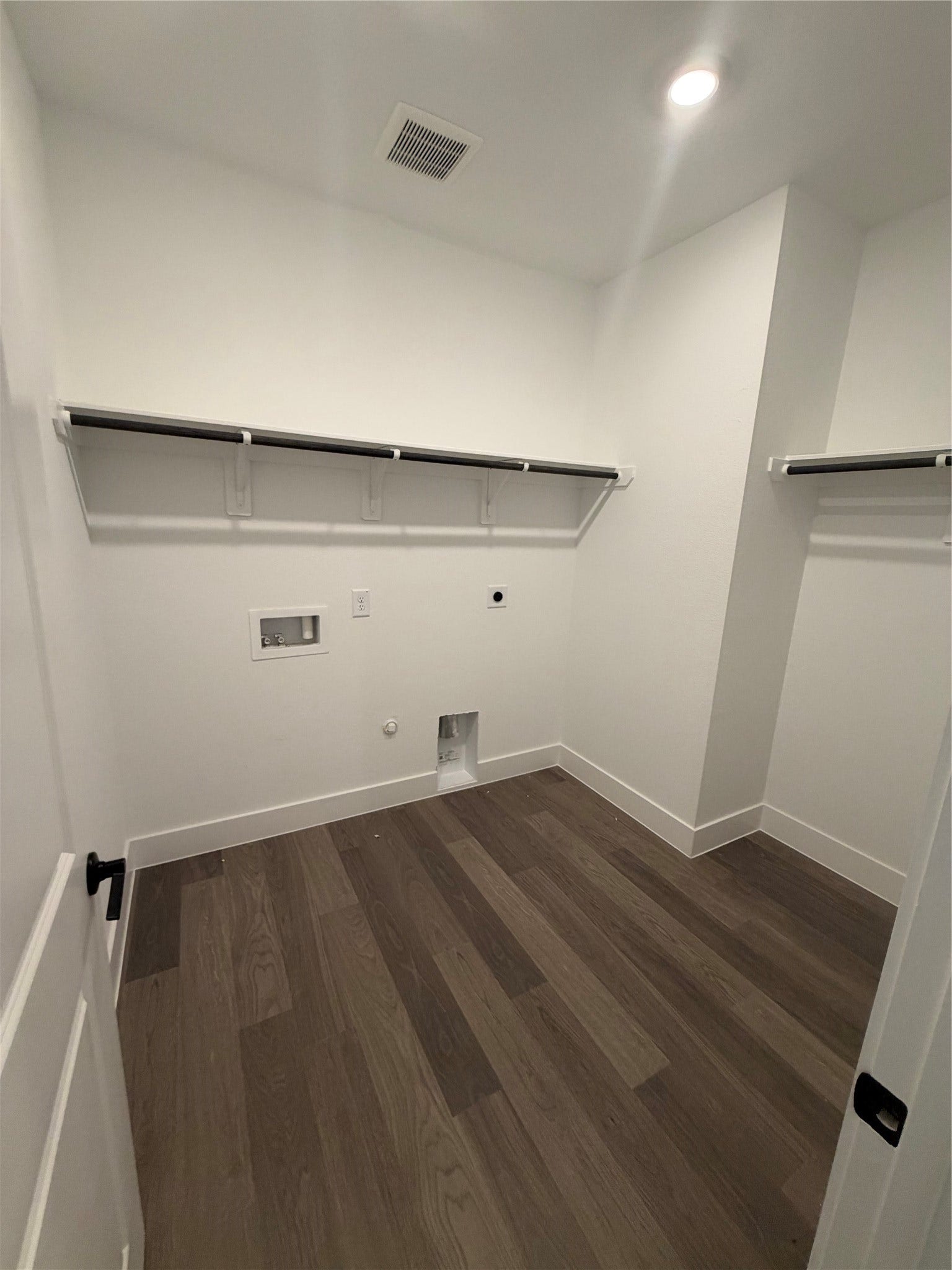 3428 Summercrisp Hollow Lane, Pearland, TX 77581 Spacious laundry room with sleek hardwood flooring, ample shelving, and hookups for washer and dryer.