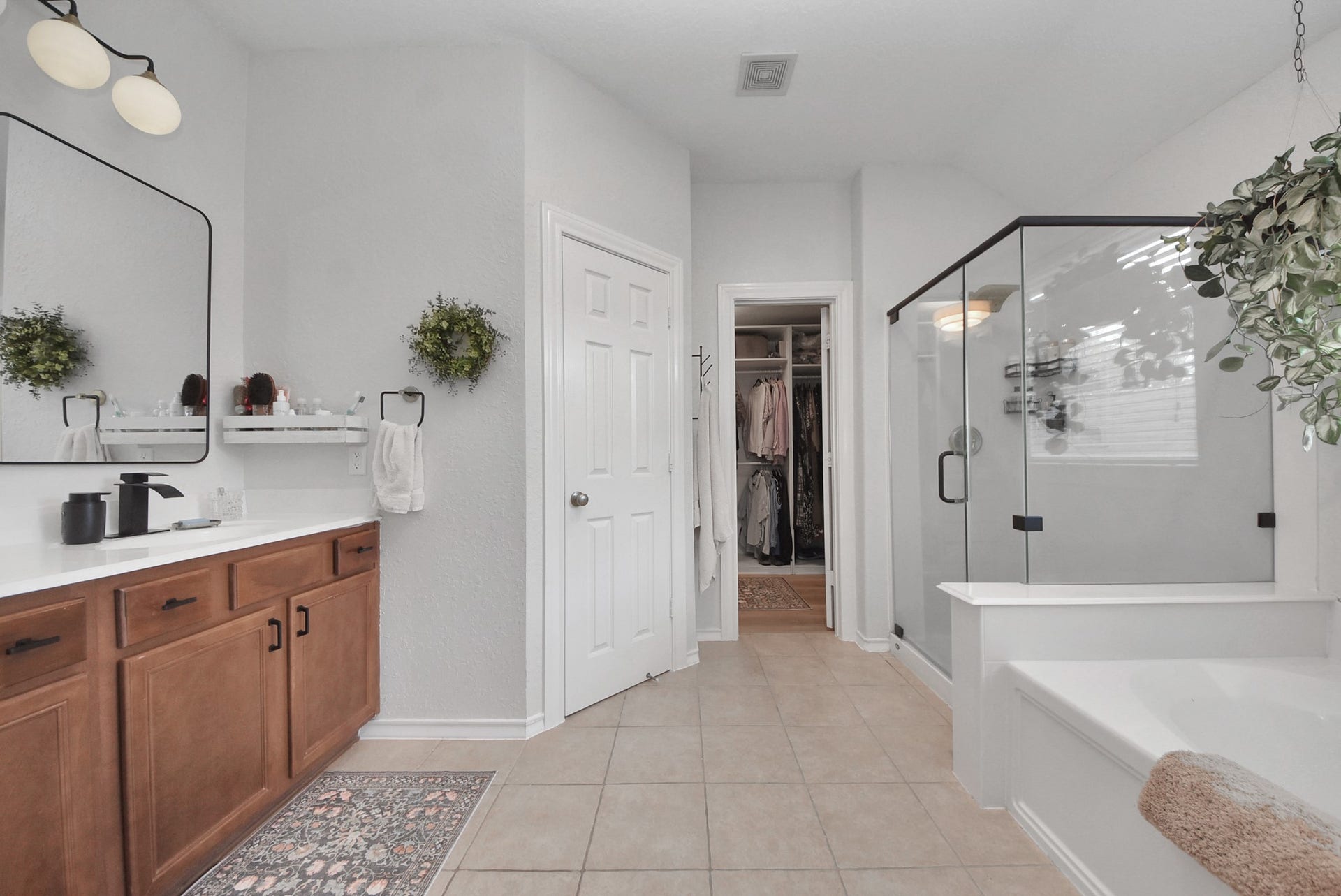 The primary en-suite has been thoughtfully upgraded, offers a separate tub and shower, and includes a sophisticated closet organization system.