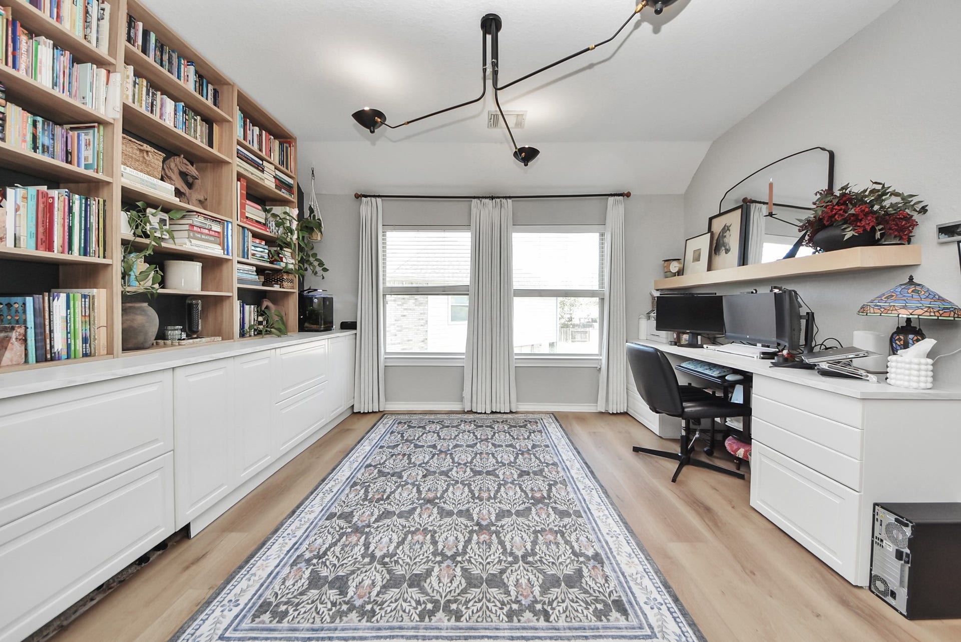 At the top of the stairs, a large game room sits with built-in shelving and ample storage. A perfect flex space!