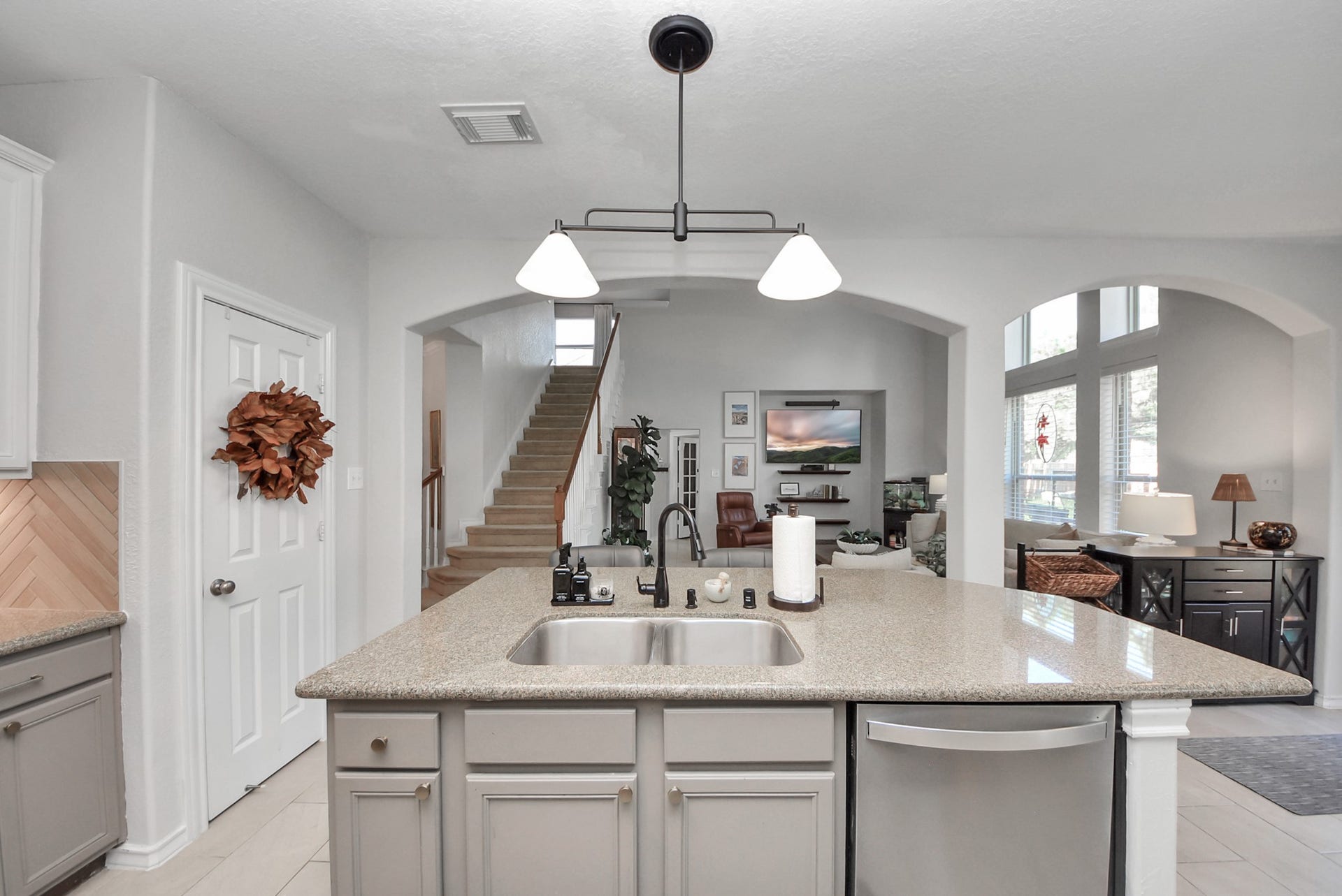 Ample counter space and a spacious island with a double-basin sink make meal preparation and entertaining easy.