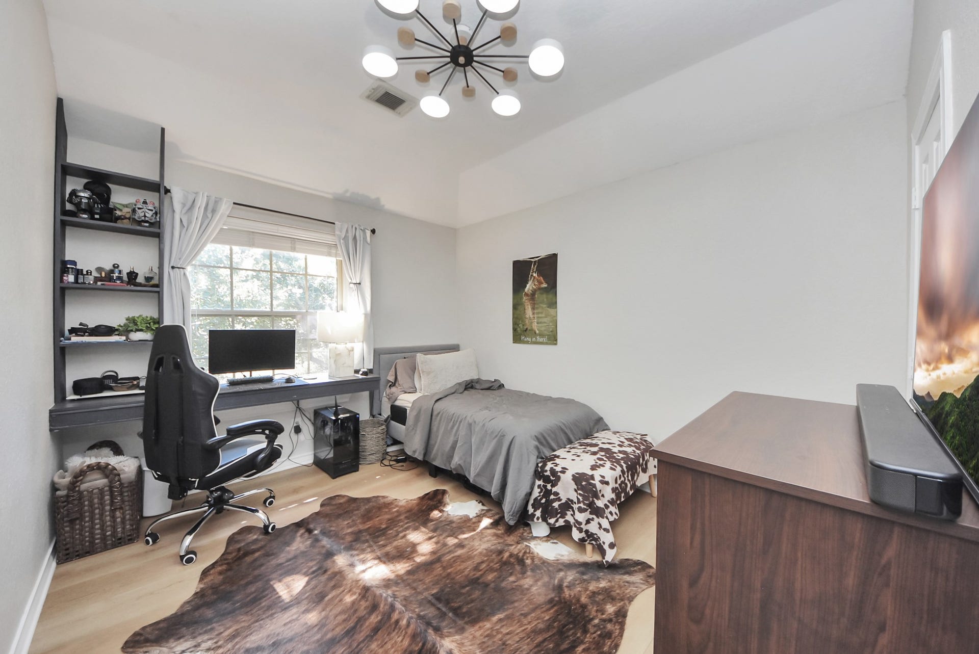 Another secondary bedroom with a custom-built desk area.