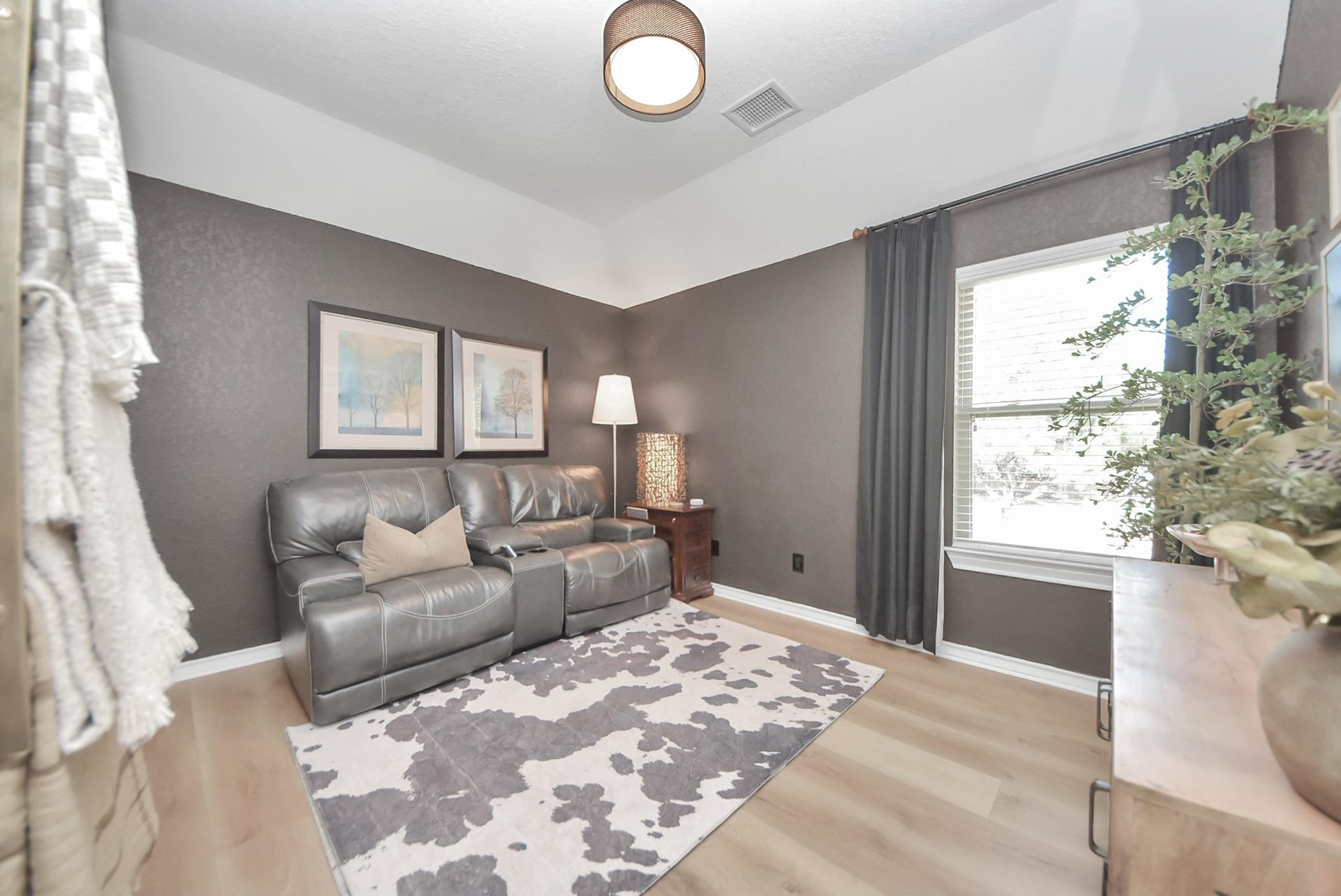 Just off the game room sits a secondary bedroom, currently being used as a TV room