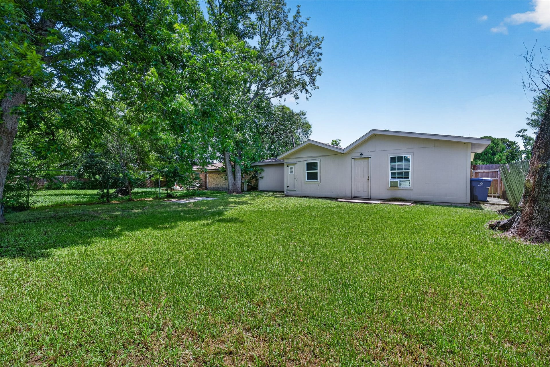 3408 Palm Avenue, Texas City, TX 77590 Charming single-story home with a spacious backyard, shaded by mature trees. Ideal for outdoor activities and relaxation.