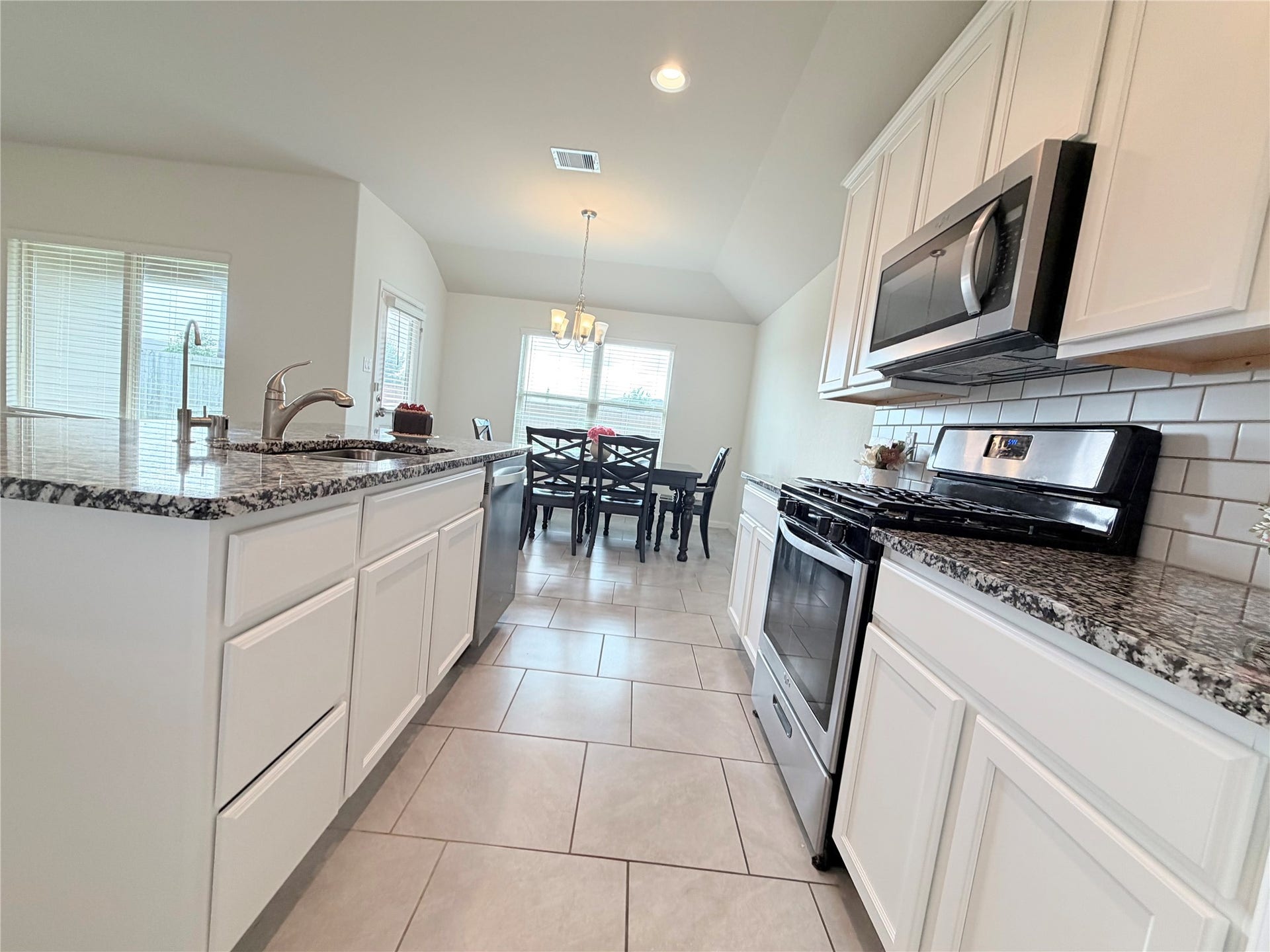 Professionally painted white cabinetry brightens the kitchen and creates a fresh, modern feel.