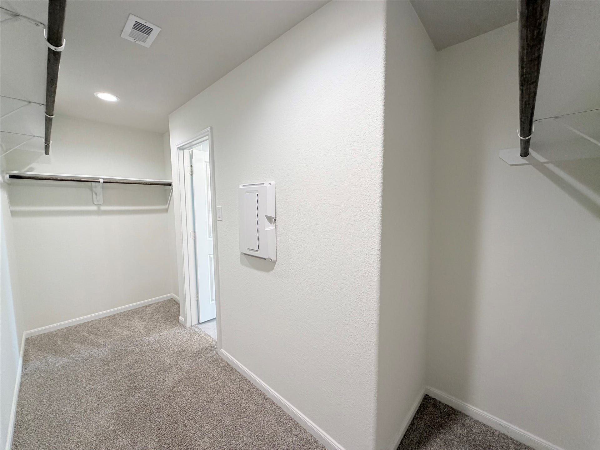 Large primary walk-in closet offers abundant storage and organization space.