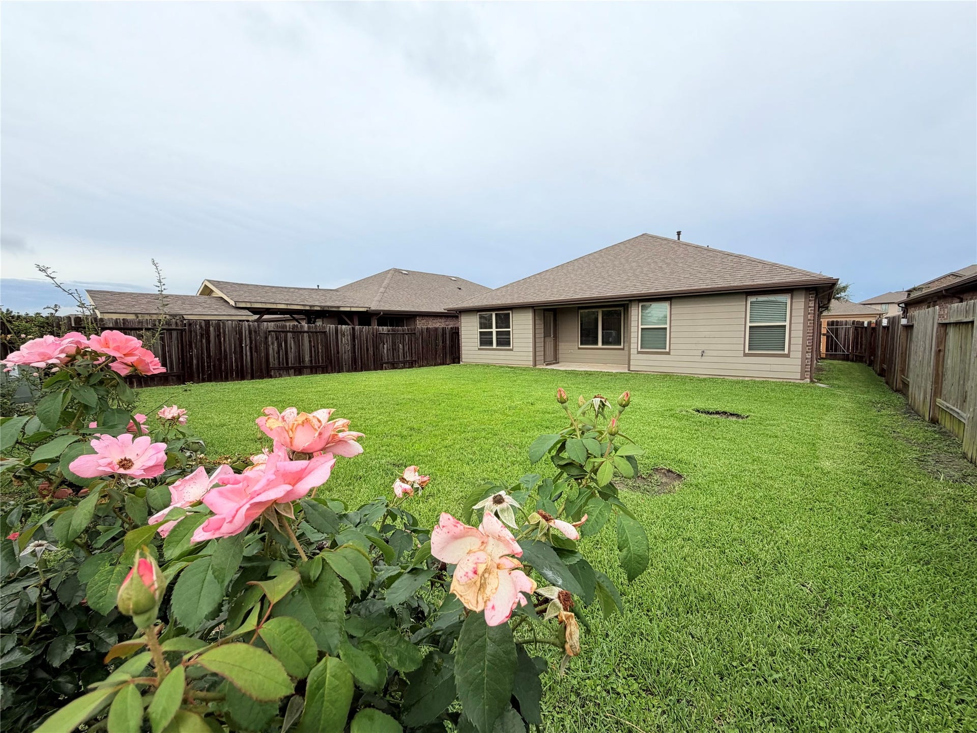 Beautiful rose garden welcomes you to an oversized backyard offer ample space for outdoor entertaining.