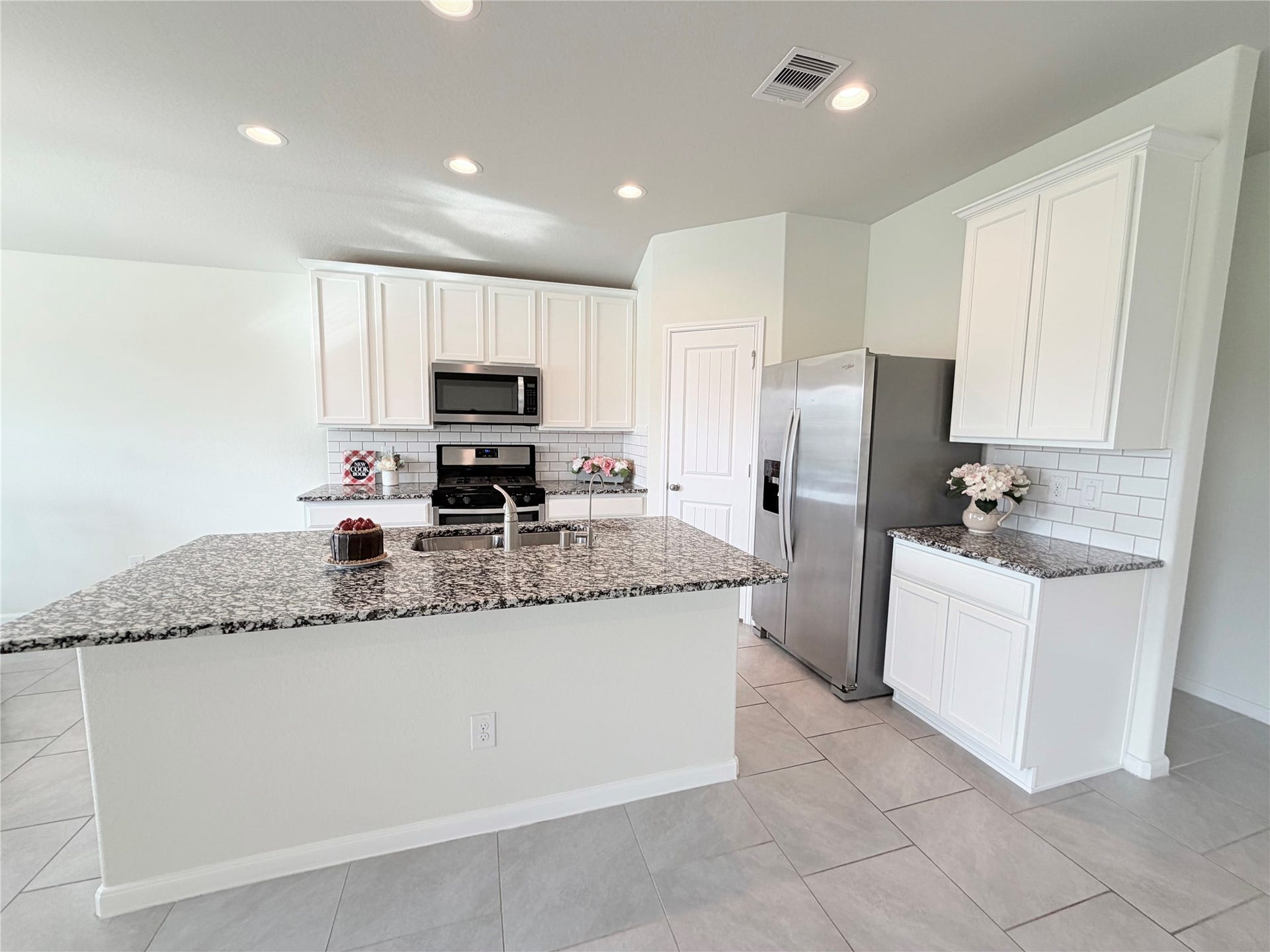 Expansive island offers additional seating- perfect for morning coffee, casual meals, or gathering with guests.