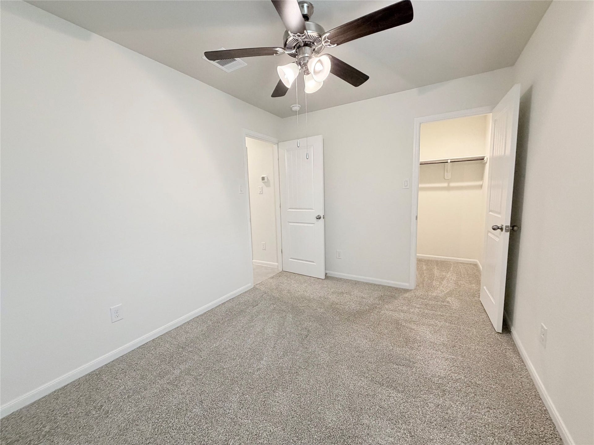 Bedroom 3 has a ceiling fan and a walk in closet.